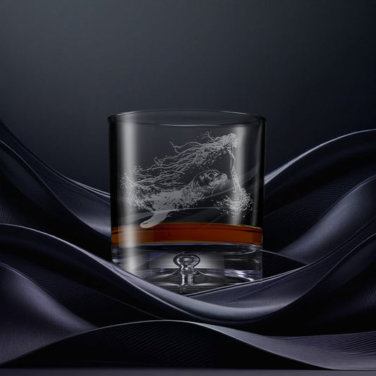 Engraved whisky glass with an  illustration of a selkie emerging from the water