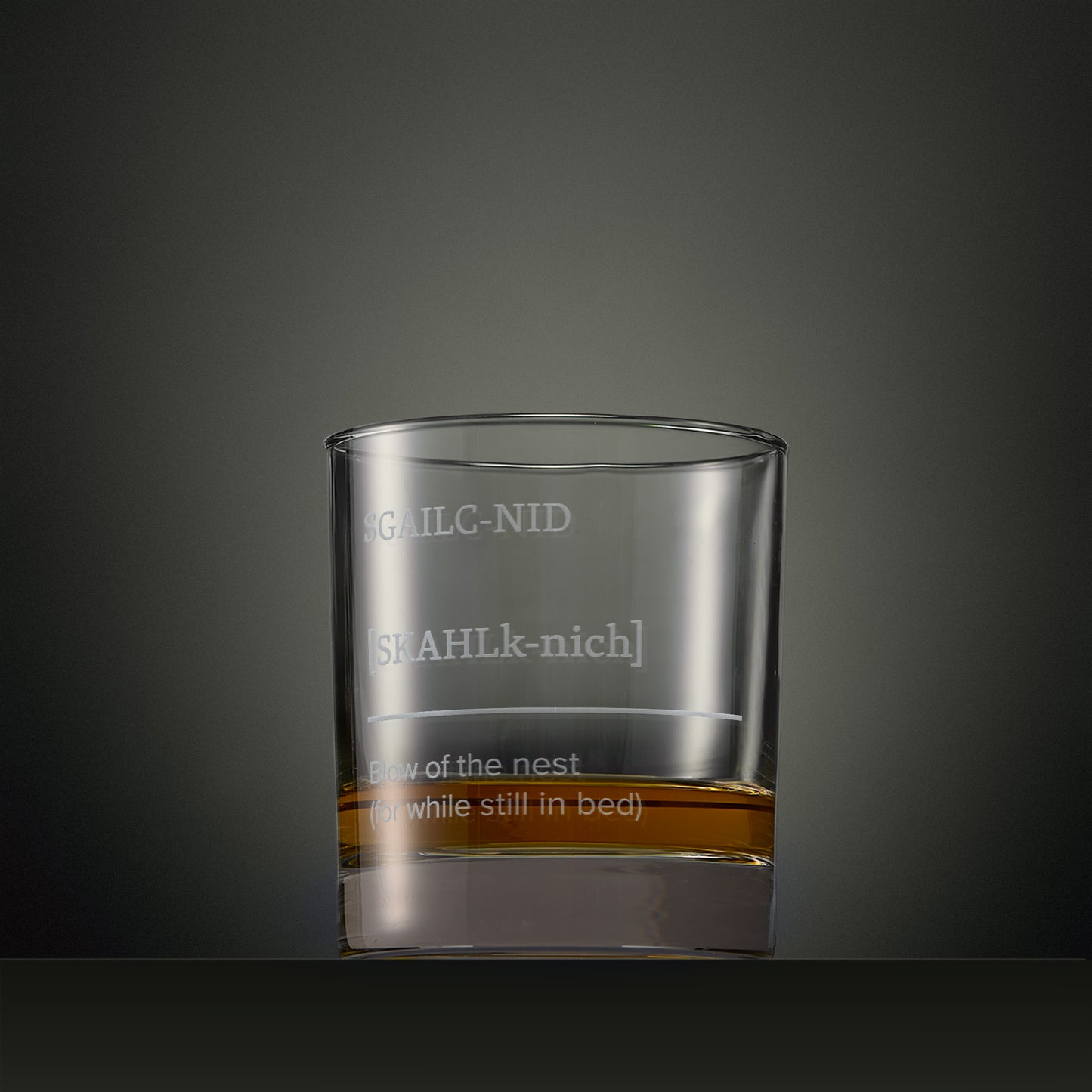 Engraved whisky glass featuring one of the Four Morning Drams Scottish Gaelic typography designs with explanatory English text.