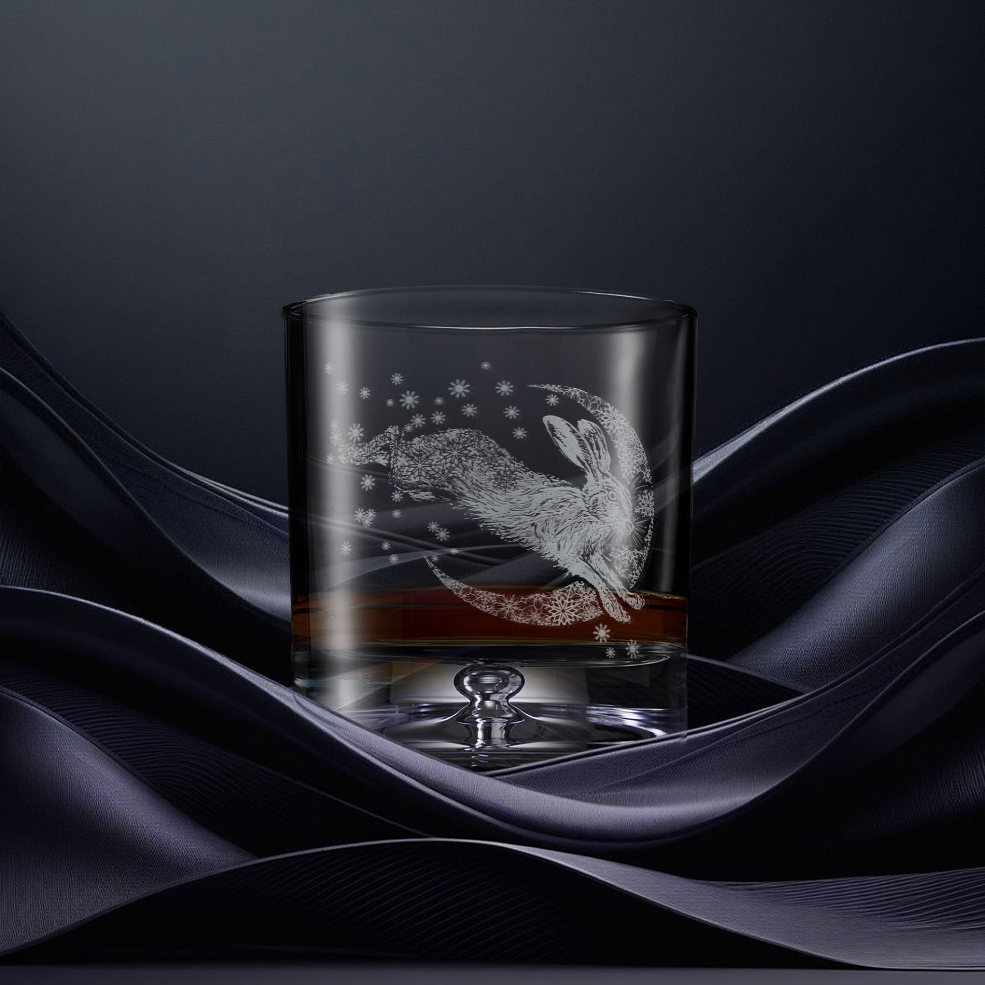 Glass tumbler with engraved design of a hare and crescent moon with snowflakes