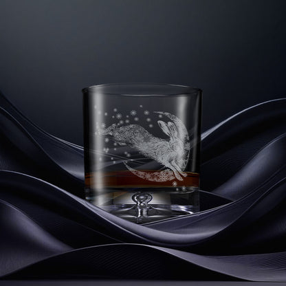 Glass tumbler with engraved design of a hare and crescent moon with snowflakes