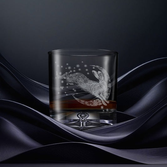 Glass tumbler with engraved design of a hare and crescent moon with snowflakes