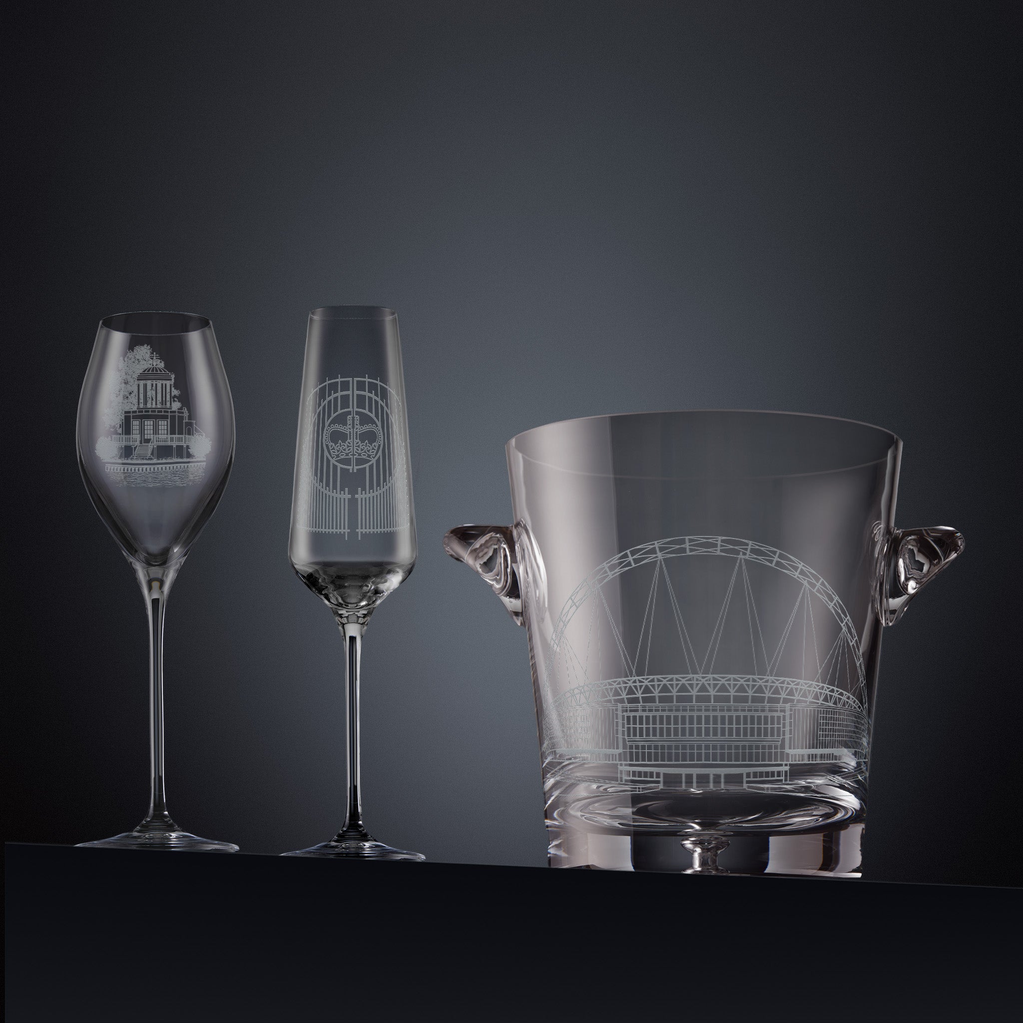 Two engraved sporting landmark prosecco glasses and a champagne cooler