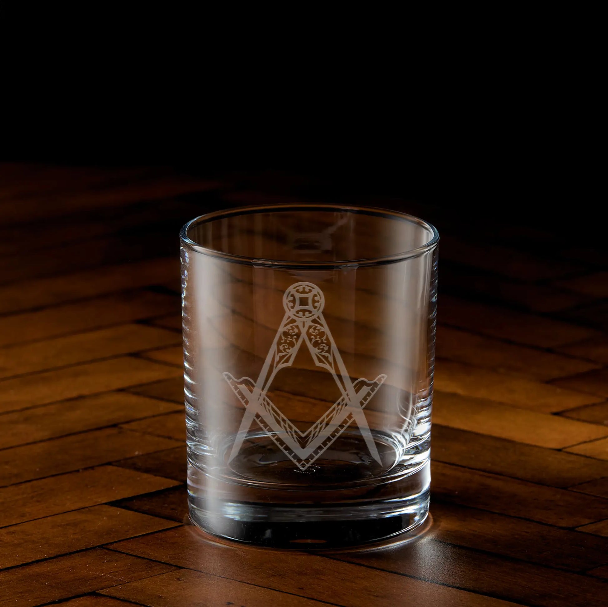 Engraved whisky glass featuring a masonic square and compass design
