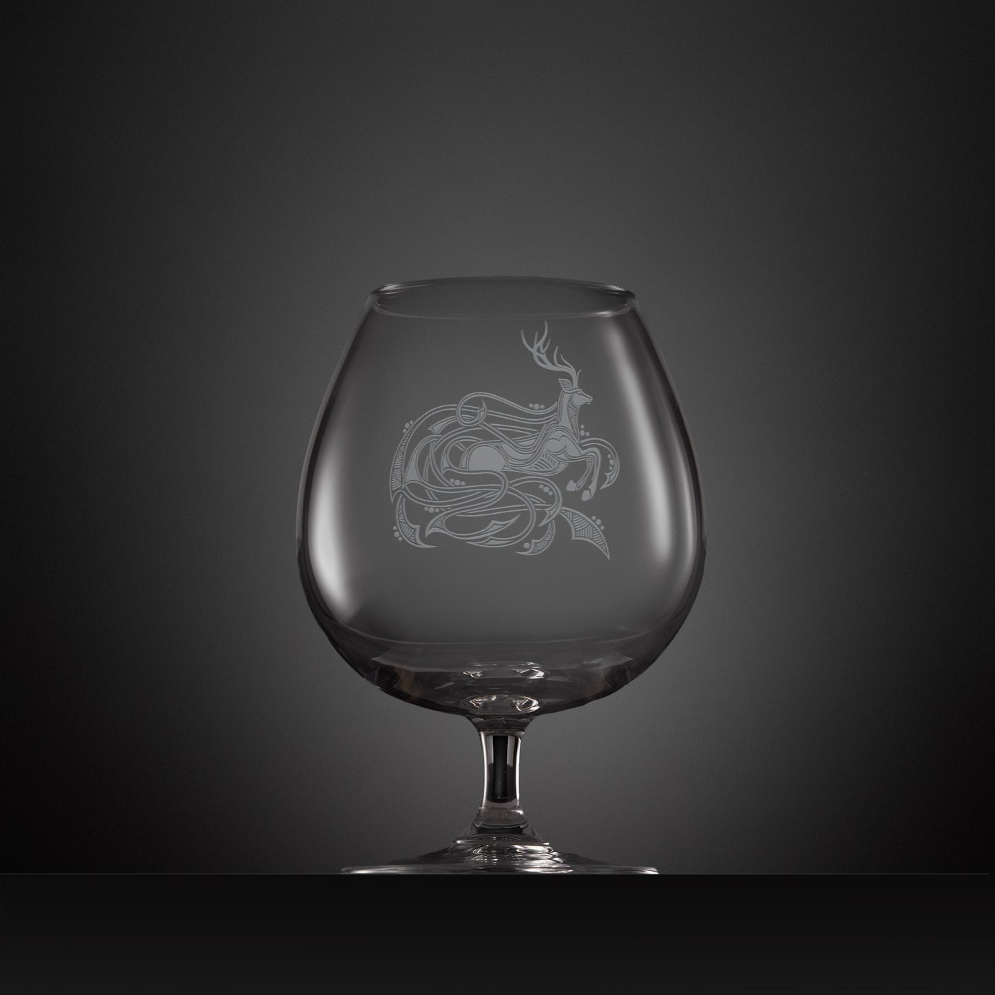 Engraved brandy glass with an  illustration of a stag entwined with Celtic knotwork