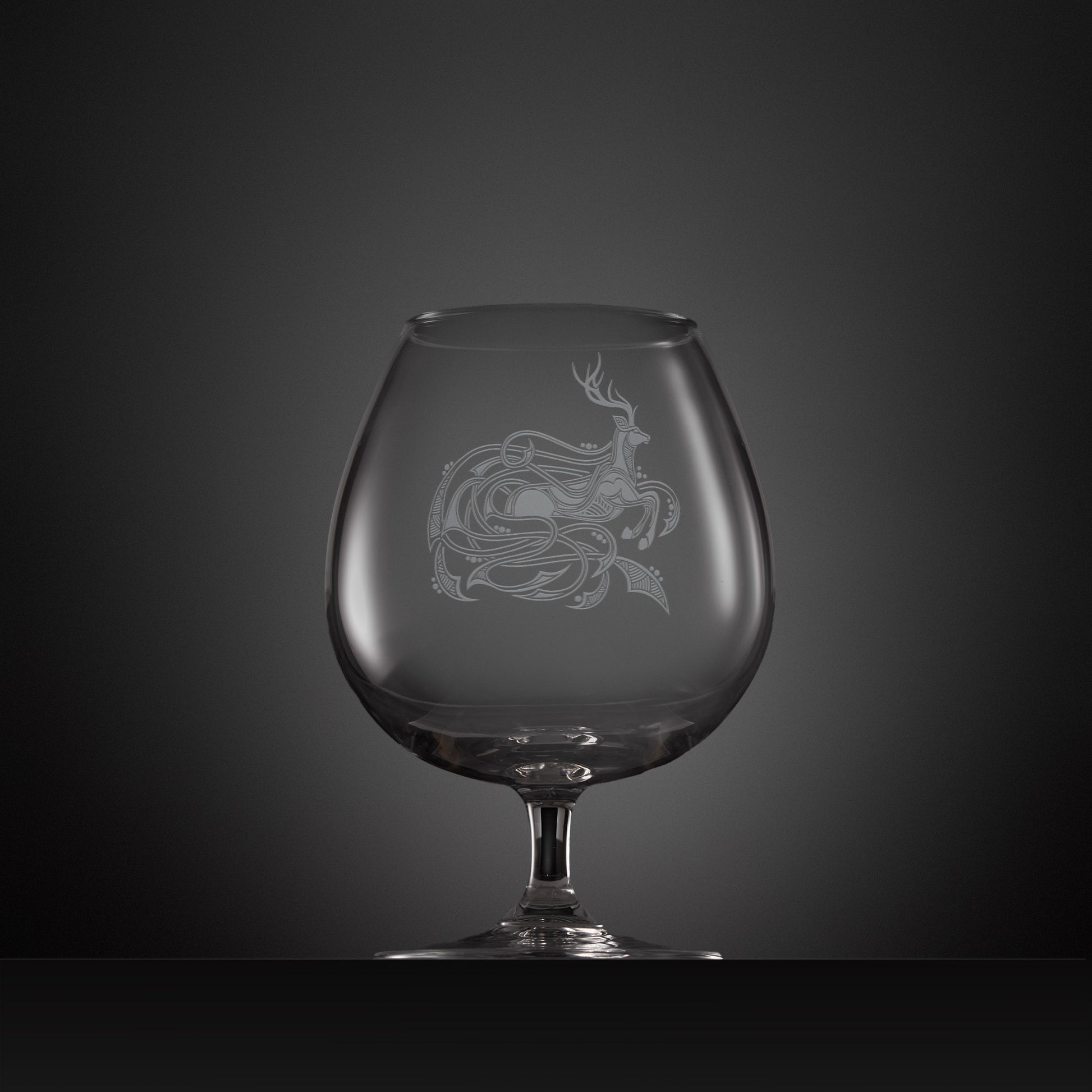 Engraved brandy glass with an  illustration of a stag entwined with Celtic knotwork