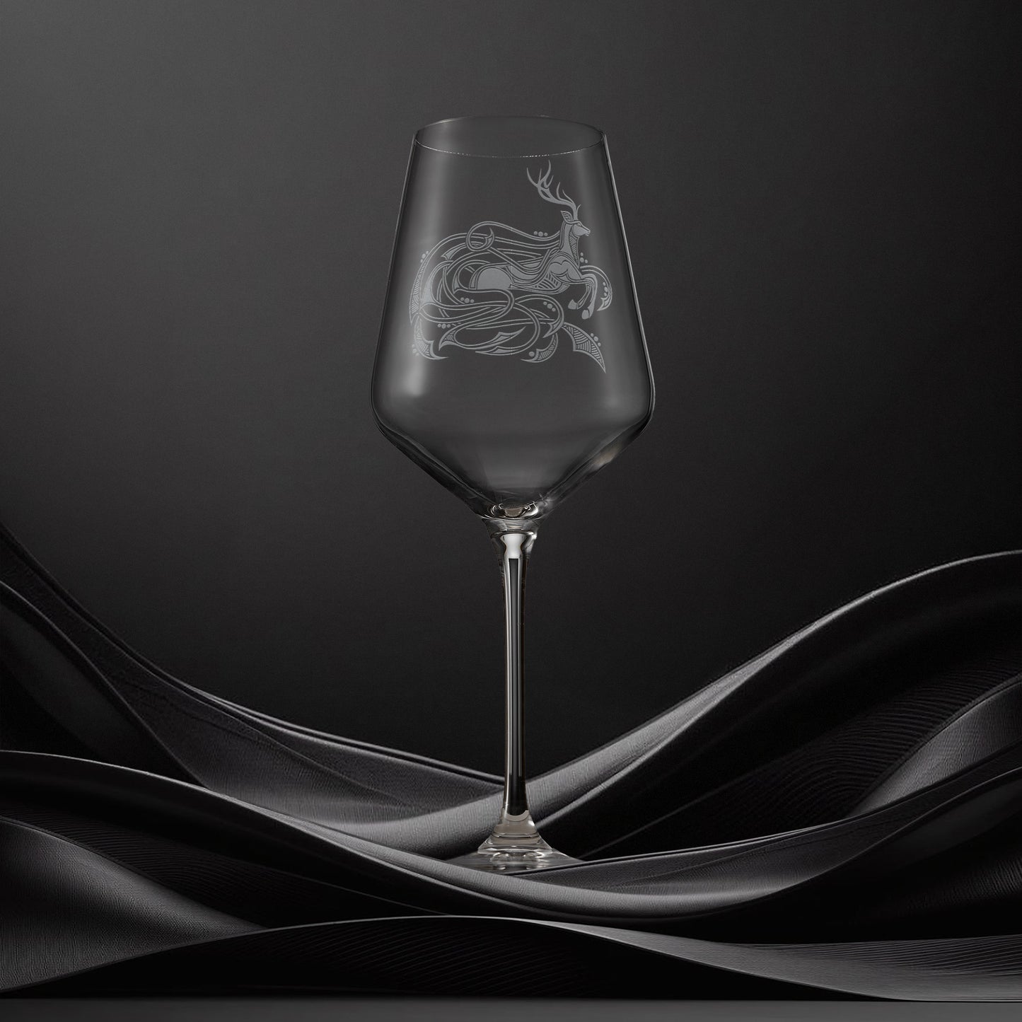 Engraved wine glass with an  illustration of a stag with flowing Celtic knotwork