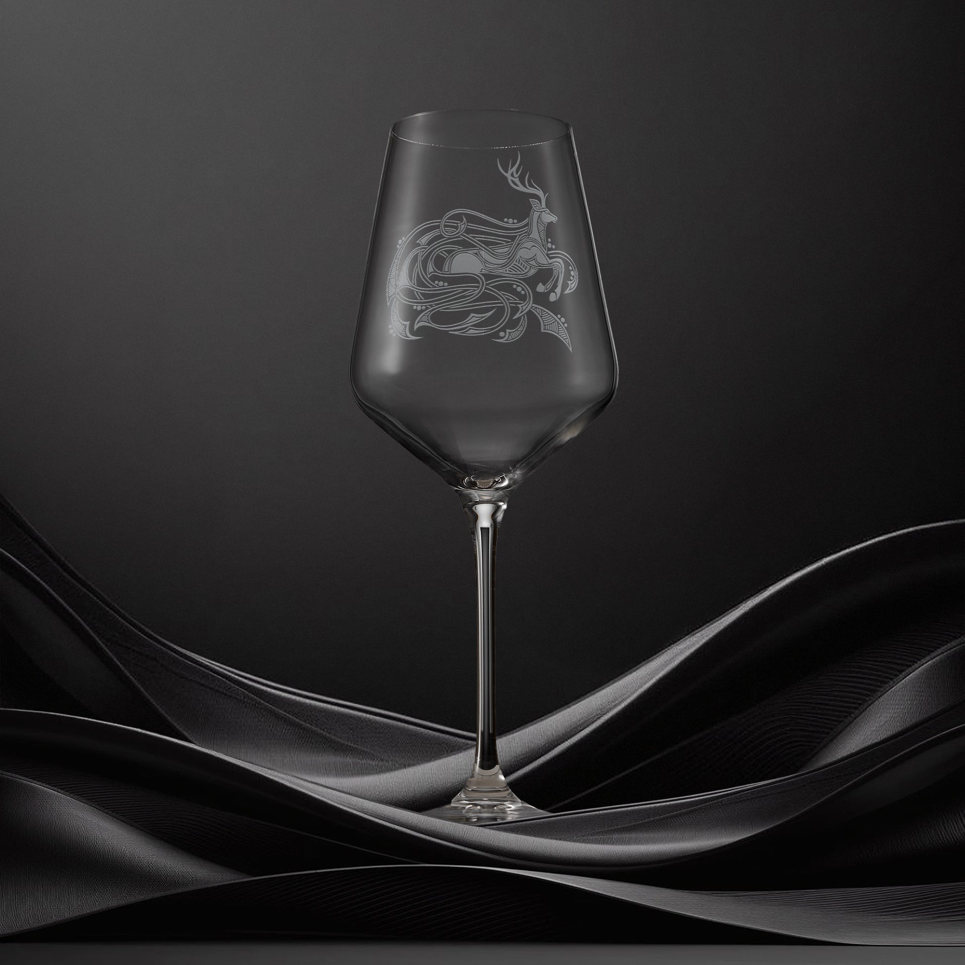 Engraved wine glass with an  illustration of a stag with flowing Celtic knotwork