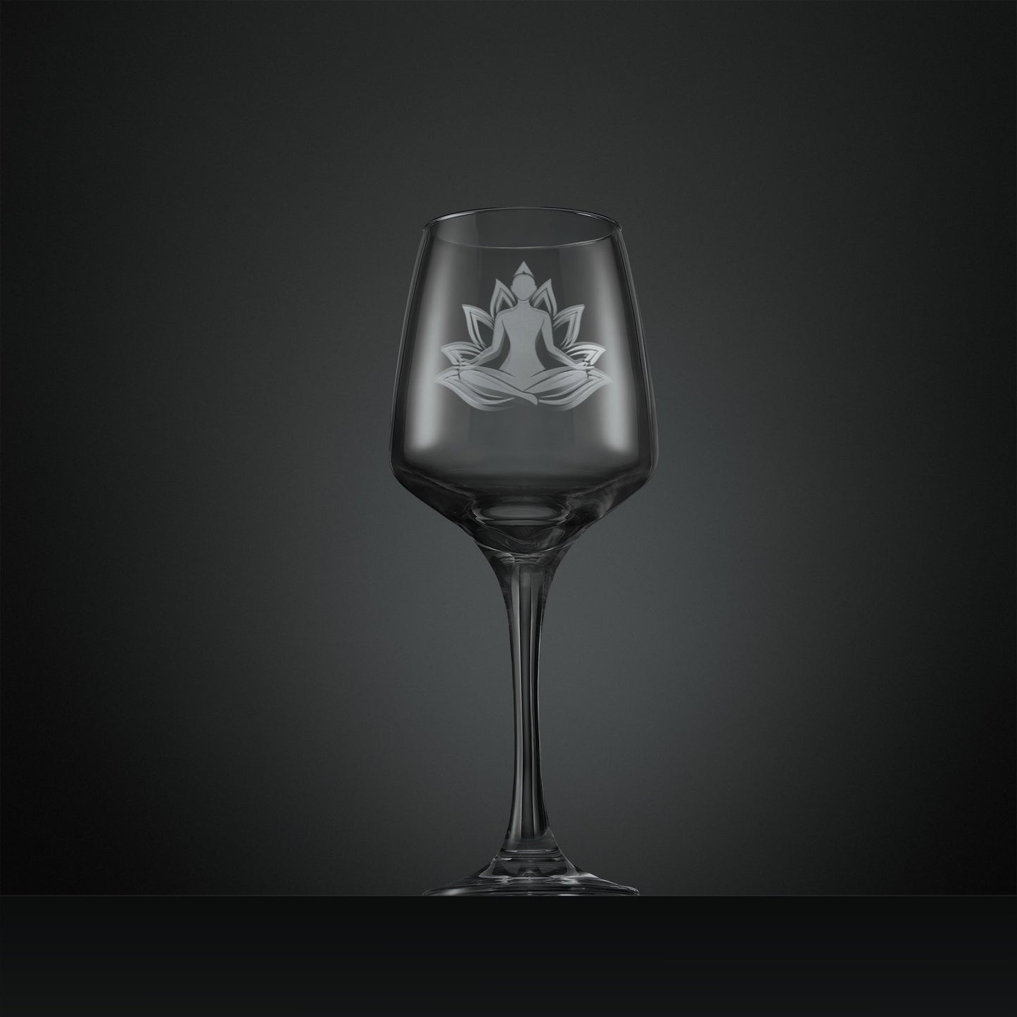 Clear wine glass with a engraved yoga design
