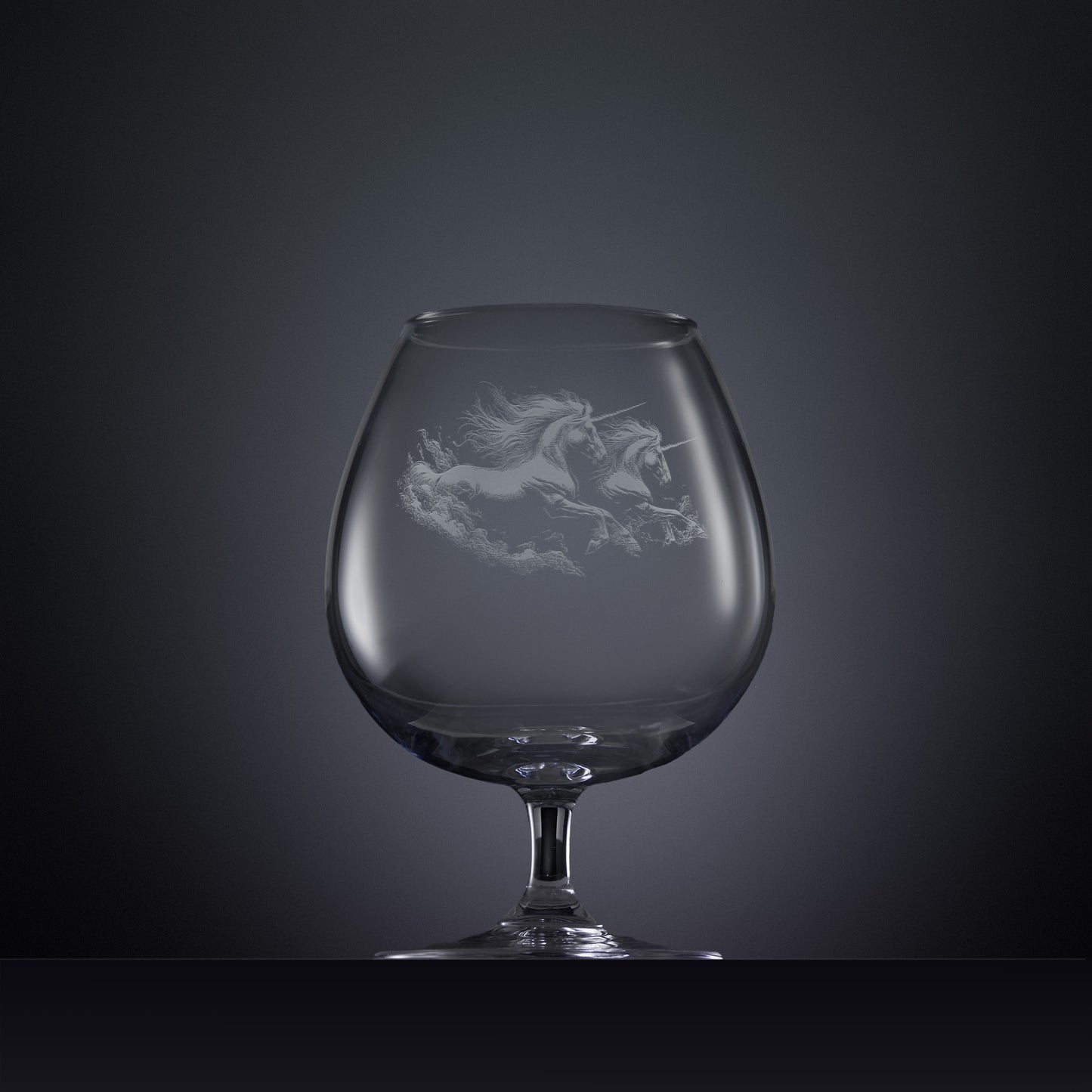 Engraved brandy glass with an  illustration of two unicorns galloping through the water
