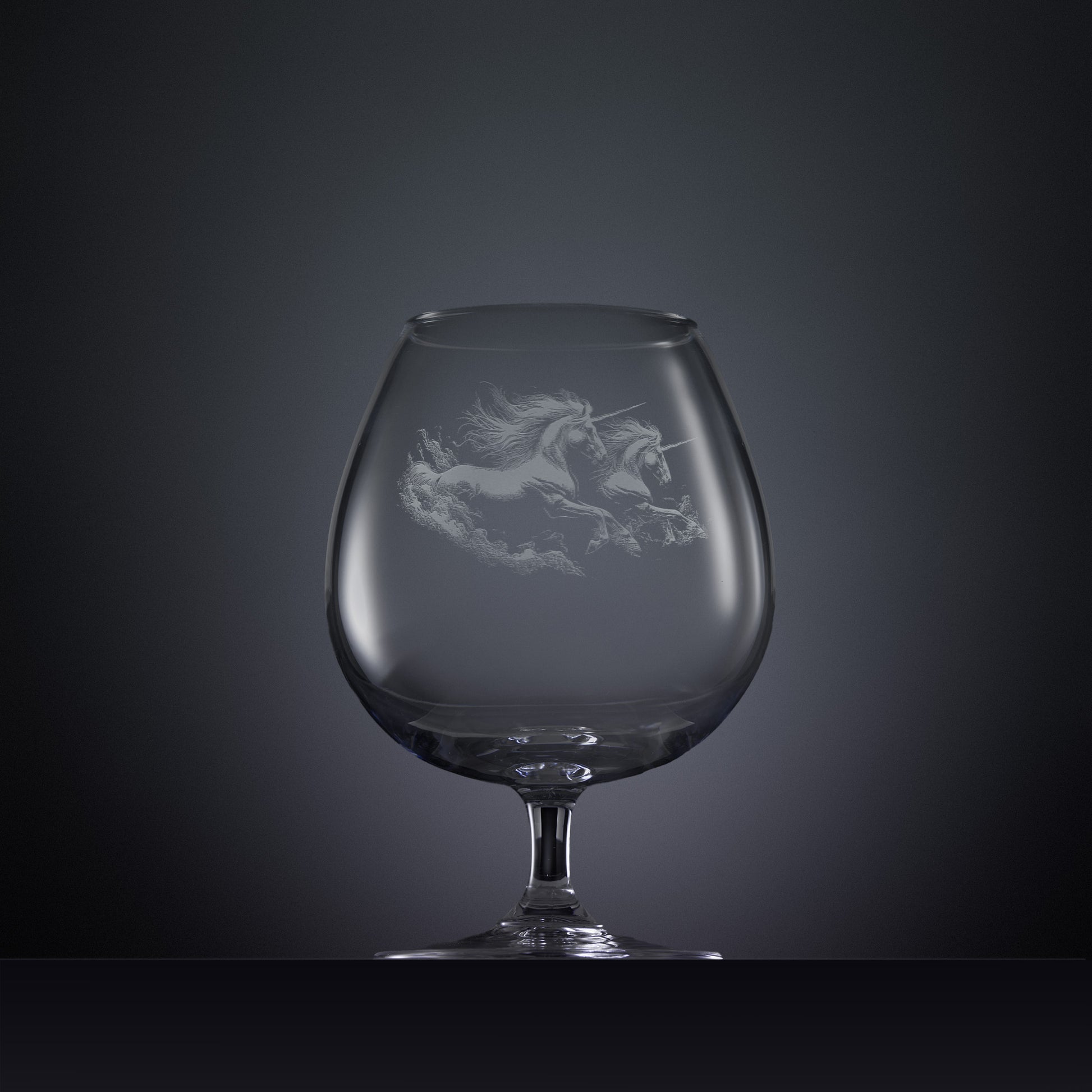 Engraved brandy glass with an  illustration of two unicorns galloping through the water