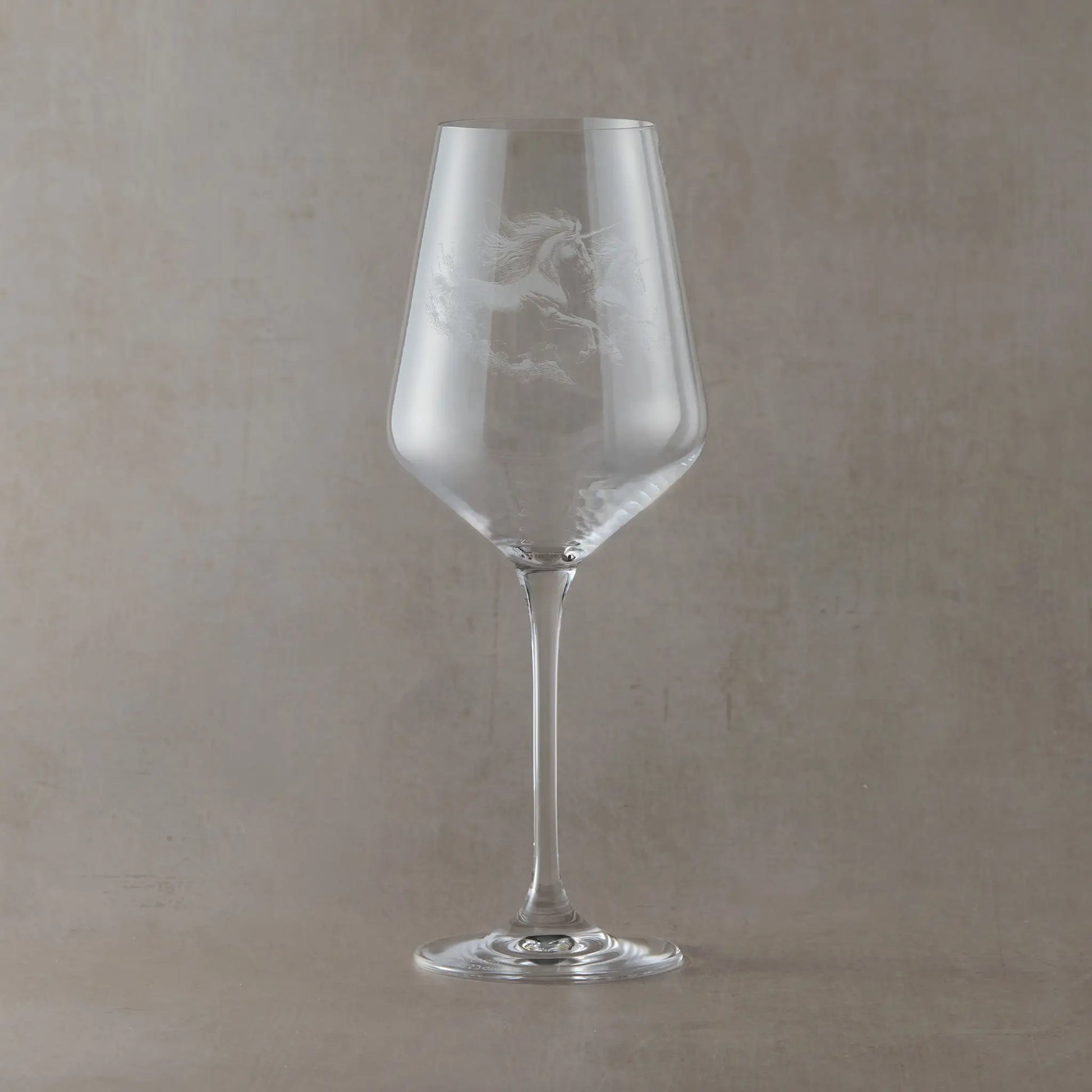 Engraved wine glass with an  illustration of two unicorns galloping 