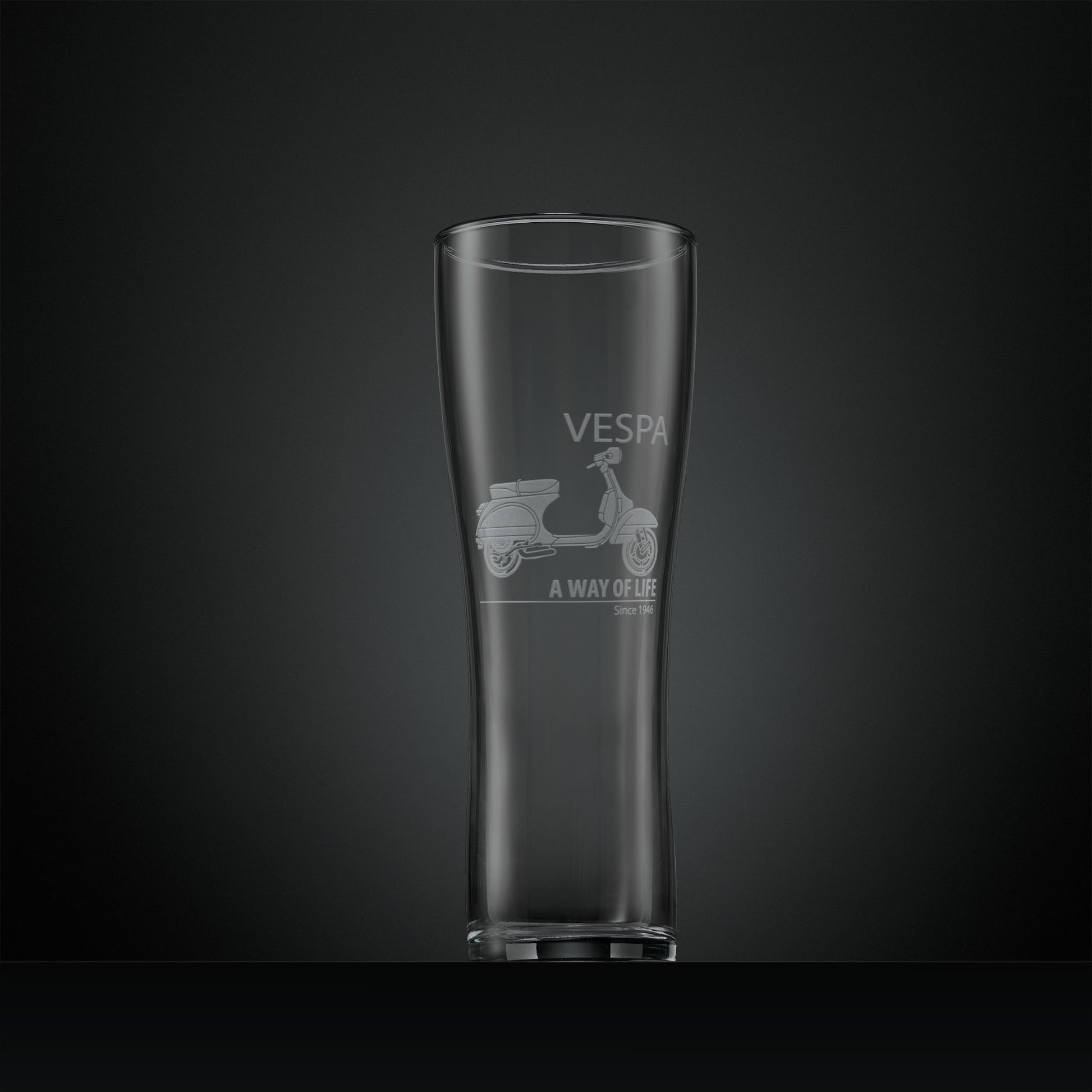 Tall pint glass engraved with a Vespa PX scooter and 'A Way of Life' text on a dark background
