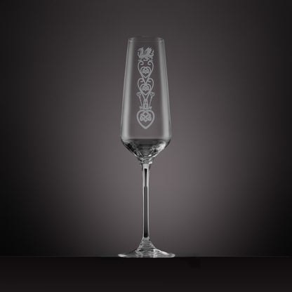 Engraved glass champagne flute featuring a celtic knotwork lovespoon and Welsh Dragon design