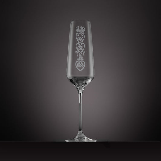 Engraved glass champagne flute featuring a celtic knotwork lovespoon and Welsh Dragon design