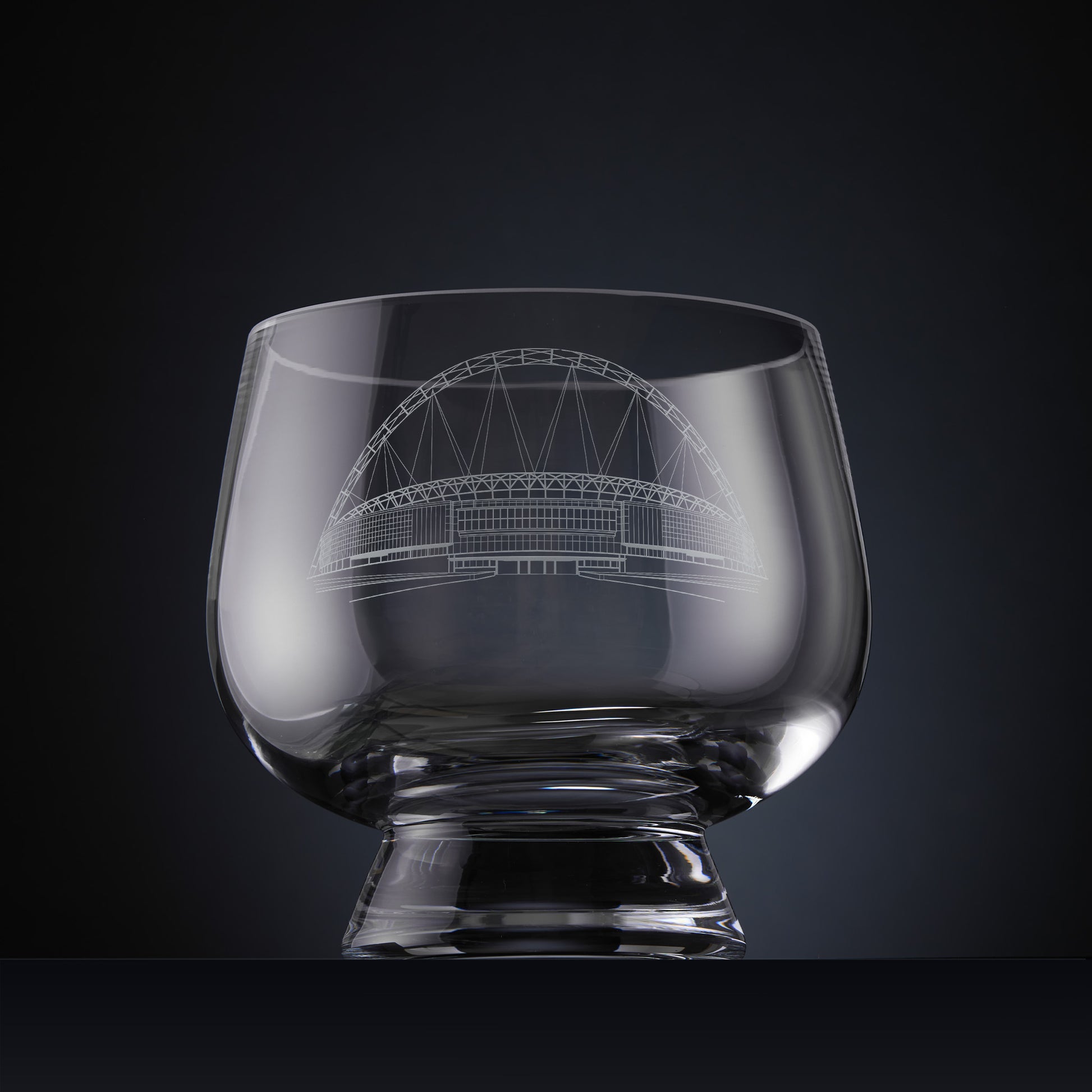 Clear glass bowl with engraved architectural illustration of Wembley Stadium.