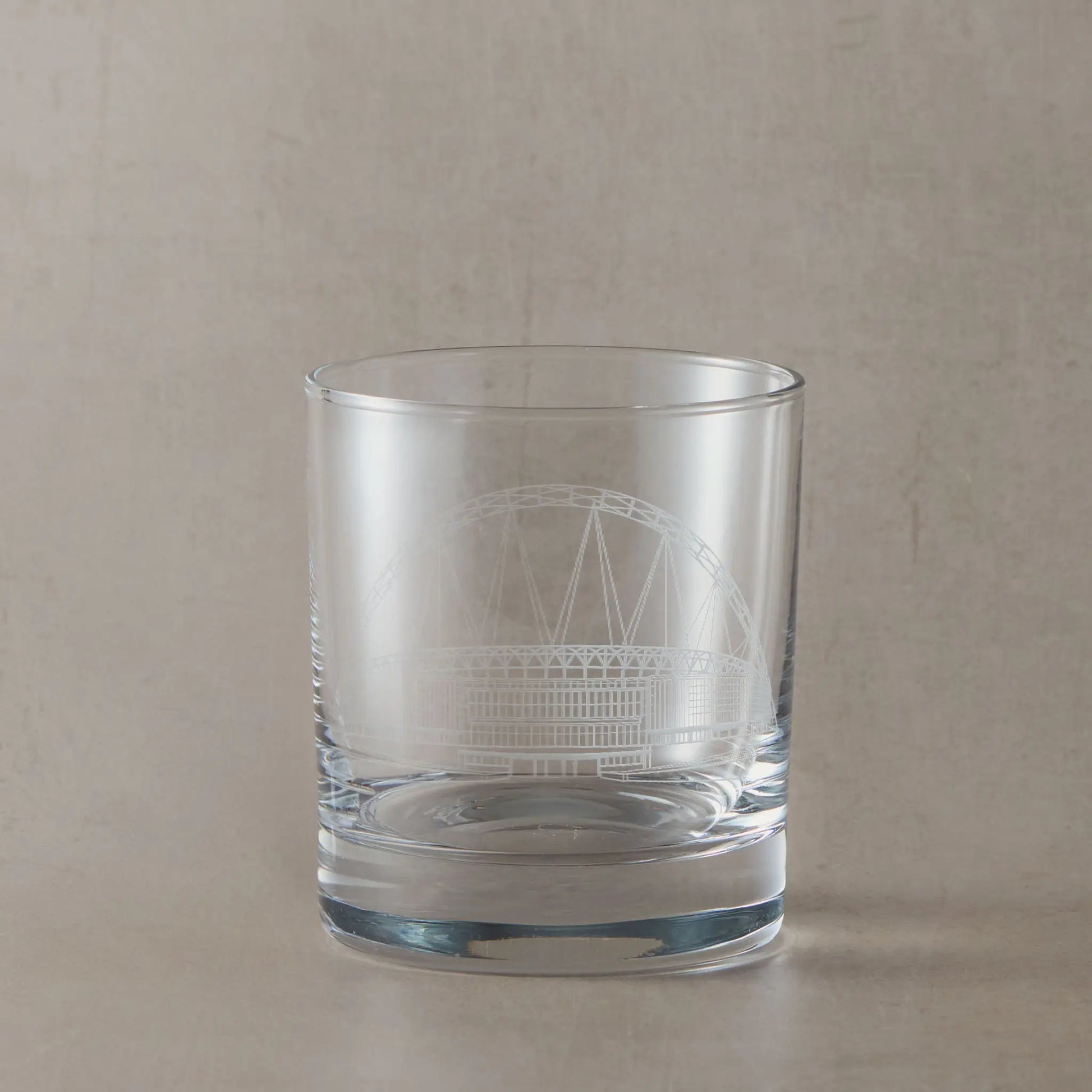 Whisky glass engraved with architectural line drawing of Wembley Stadium