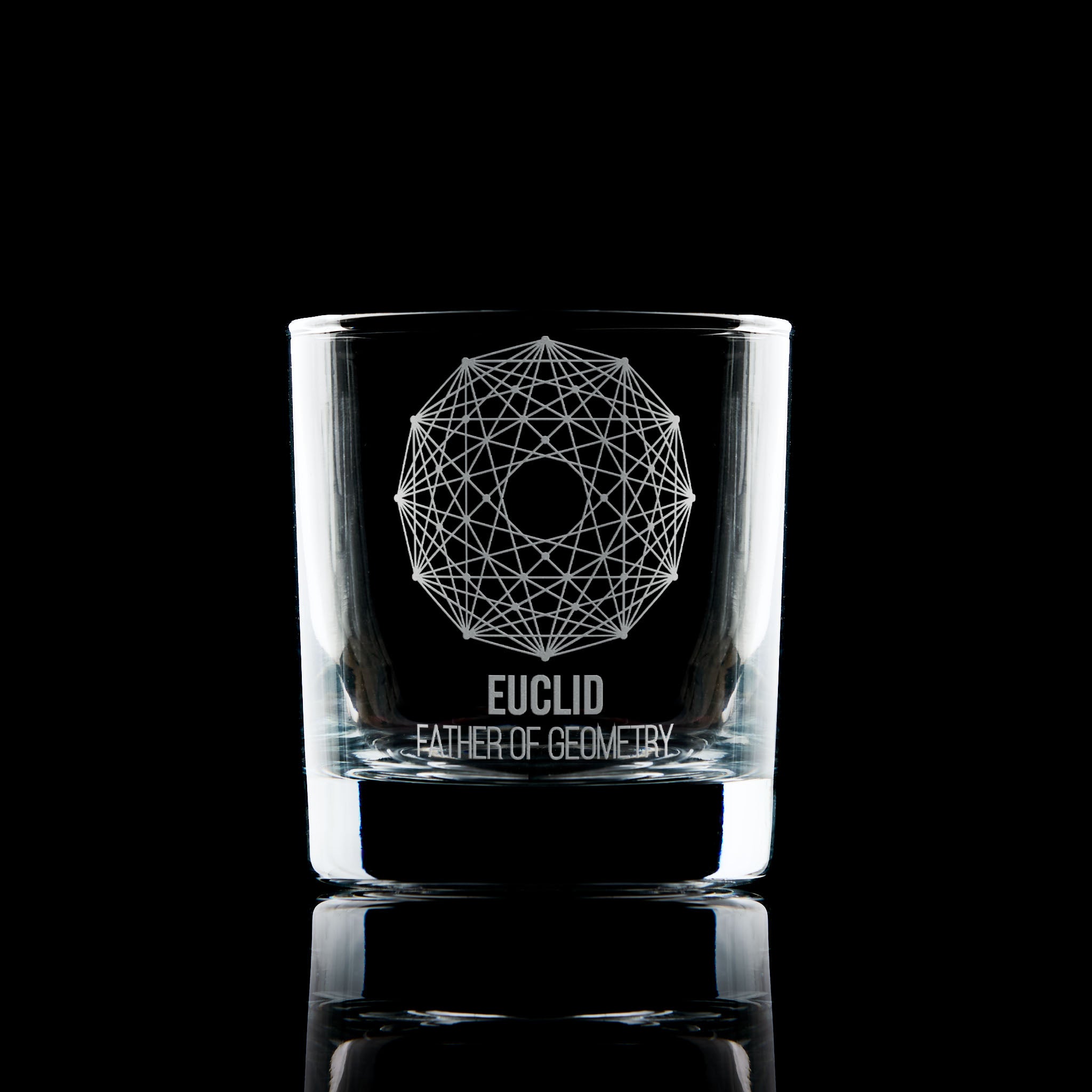 Engraved whisky glass featuring a geometric Dodecagram and Euclid inscription, photographed on black to highlight engraving clarity.