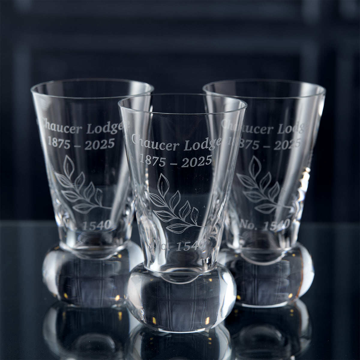 Three engraved firing glasses with commemorative lodge design and text