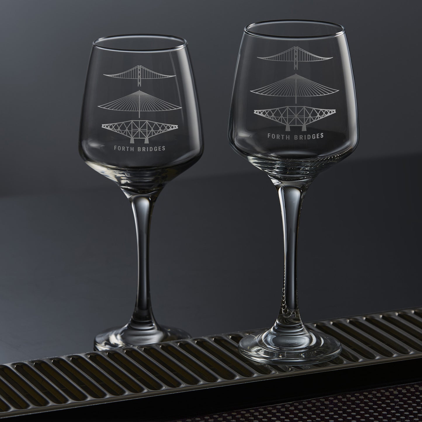 pair of wine glasses engraved with the forth rail bridge, forth road bridge and queensferry crossing