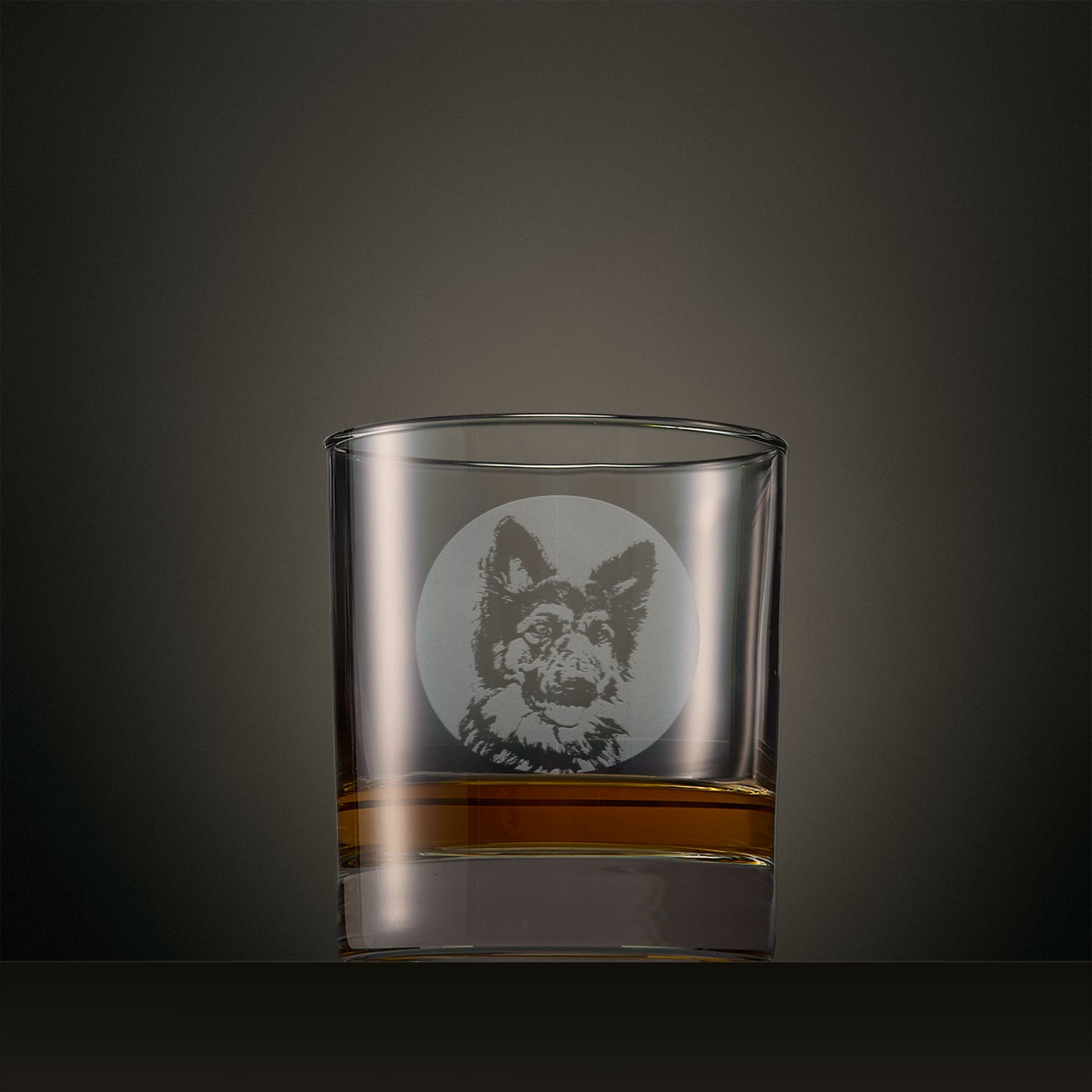 Engraved whisky glass featuring a German Shepherd portrait set within a circular design, photographed on a studio background