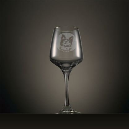 Clear wine glass with a dog design on a dark gray background