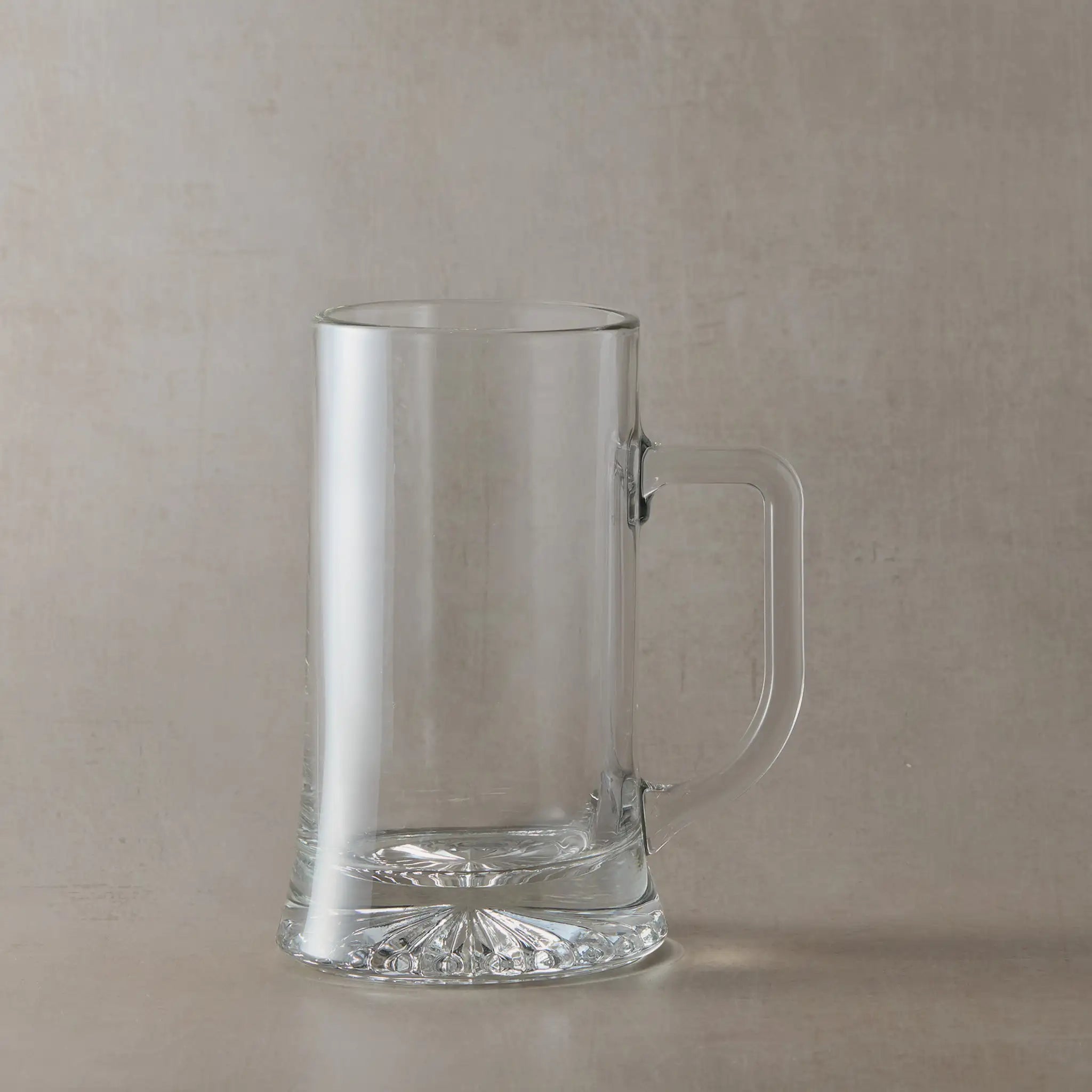 Clear tankard on a beige background