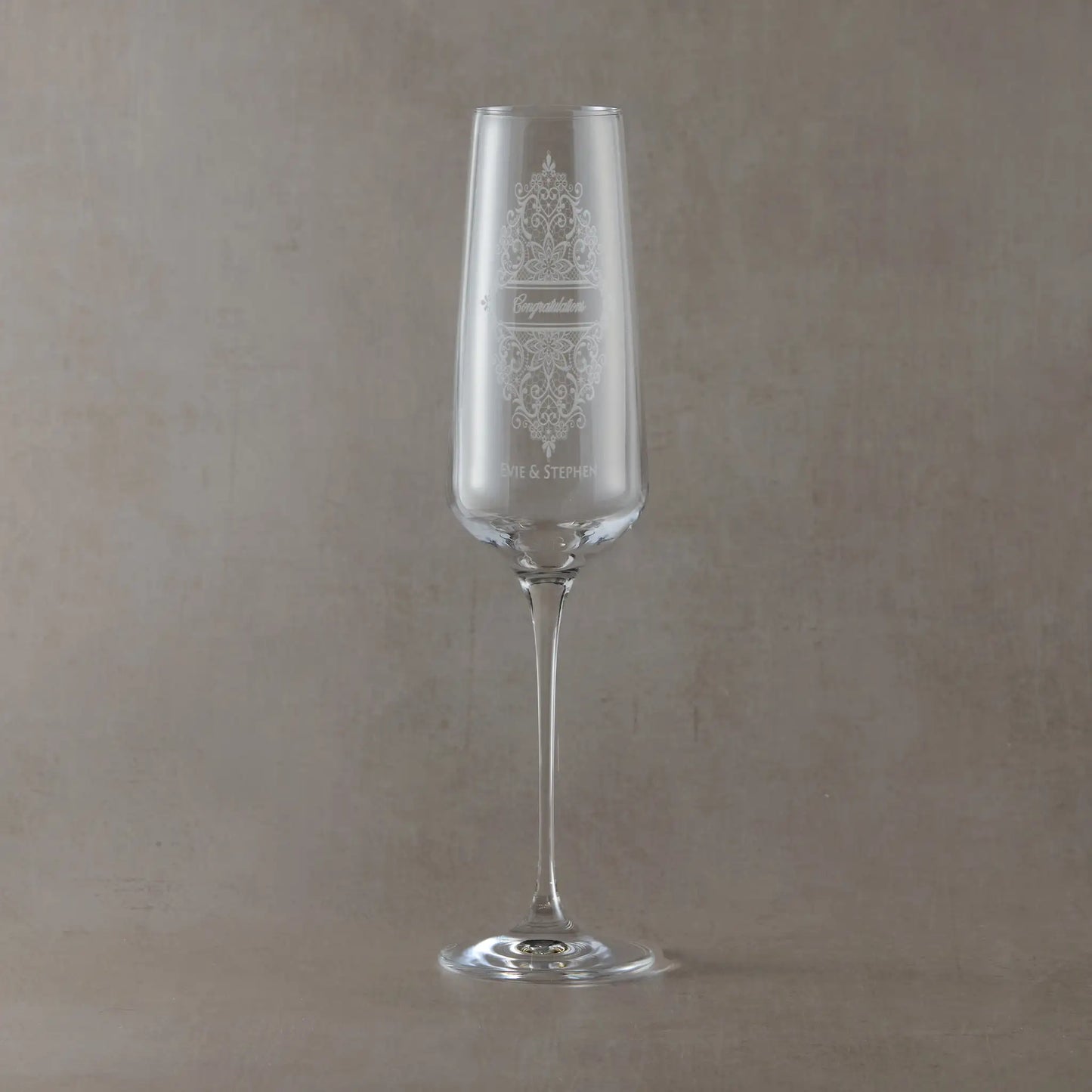 Champagne flute engraved with names and congratulations enclosed in a Guipure lace design.