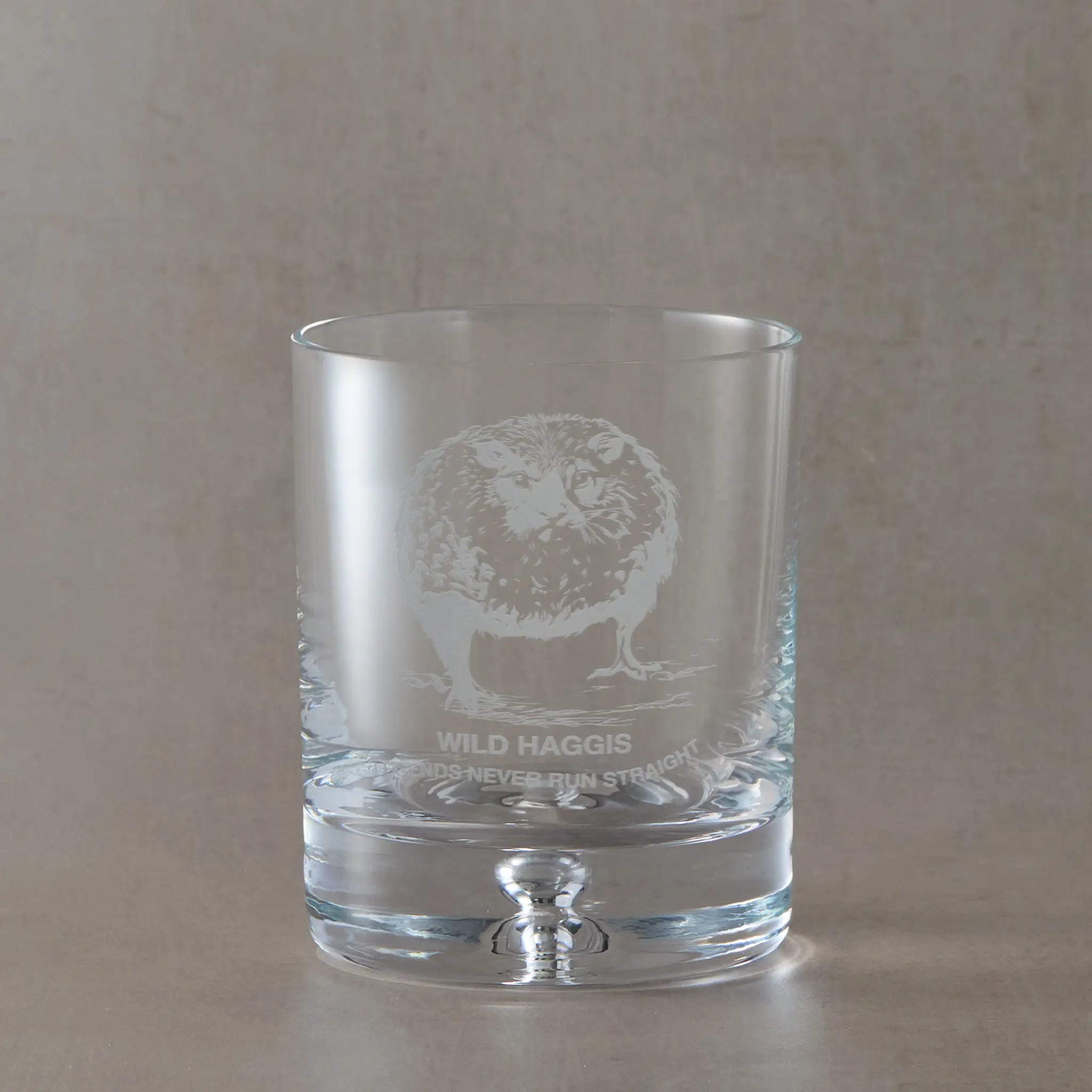 Scottish whisky glass engraved with a wild haggis and the words legends never run straight