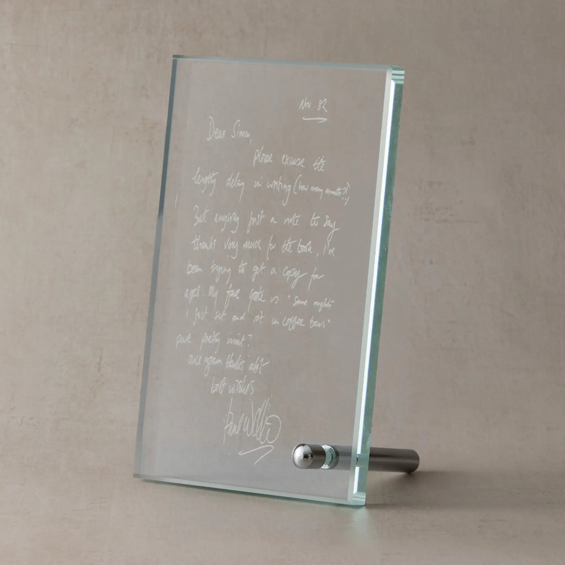 Glass display plaque engraved with a scanned handwritten letter, shown on a soft neutral studio background