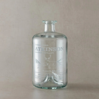Personalised decanter bottle engraved with a highland stag set against scottish mountains with inscription