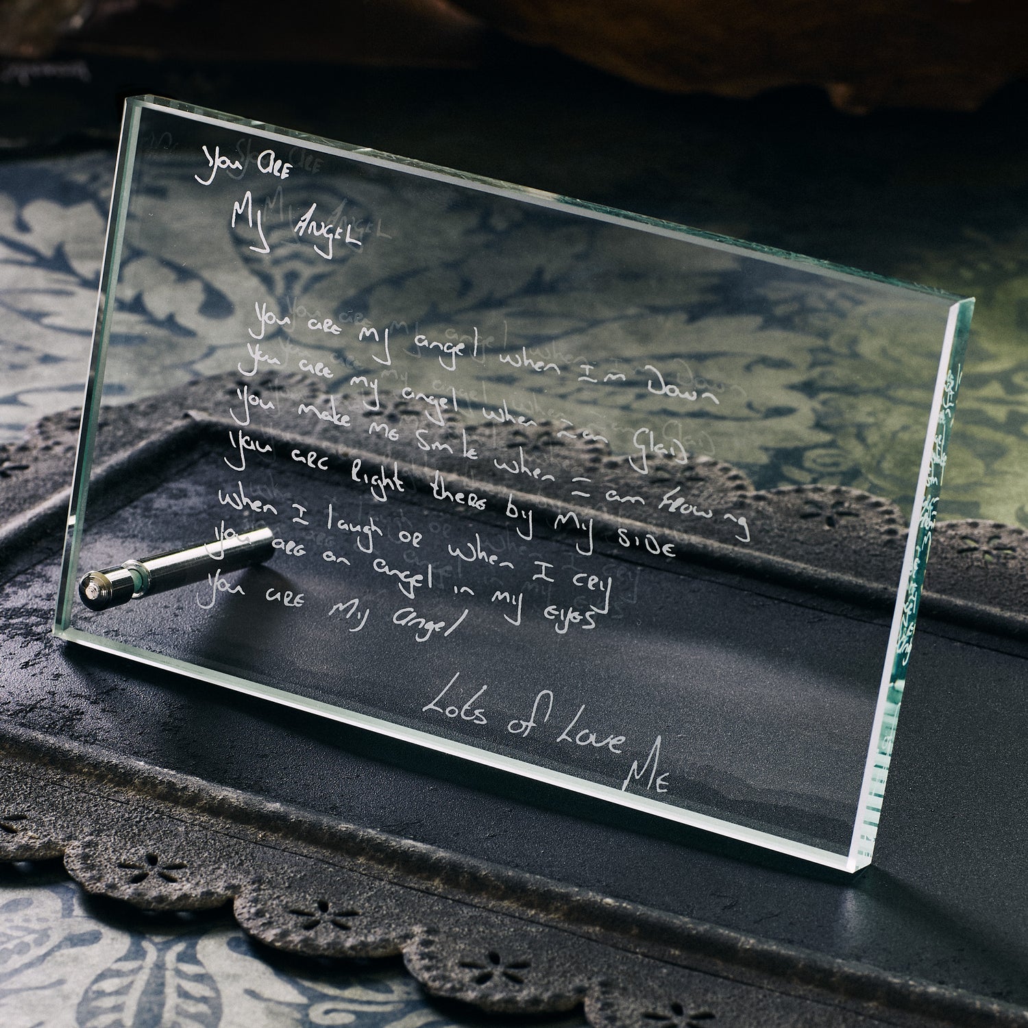 Handwritten poem etched on a glass plaque