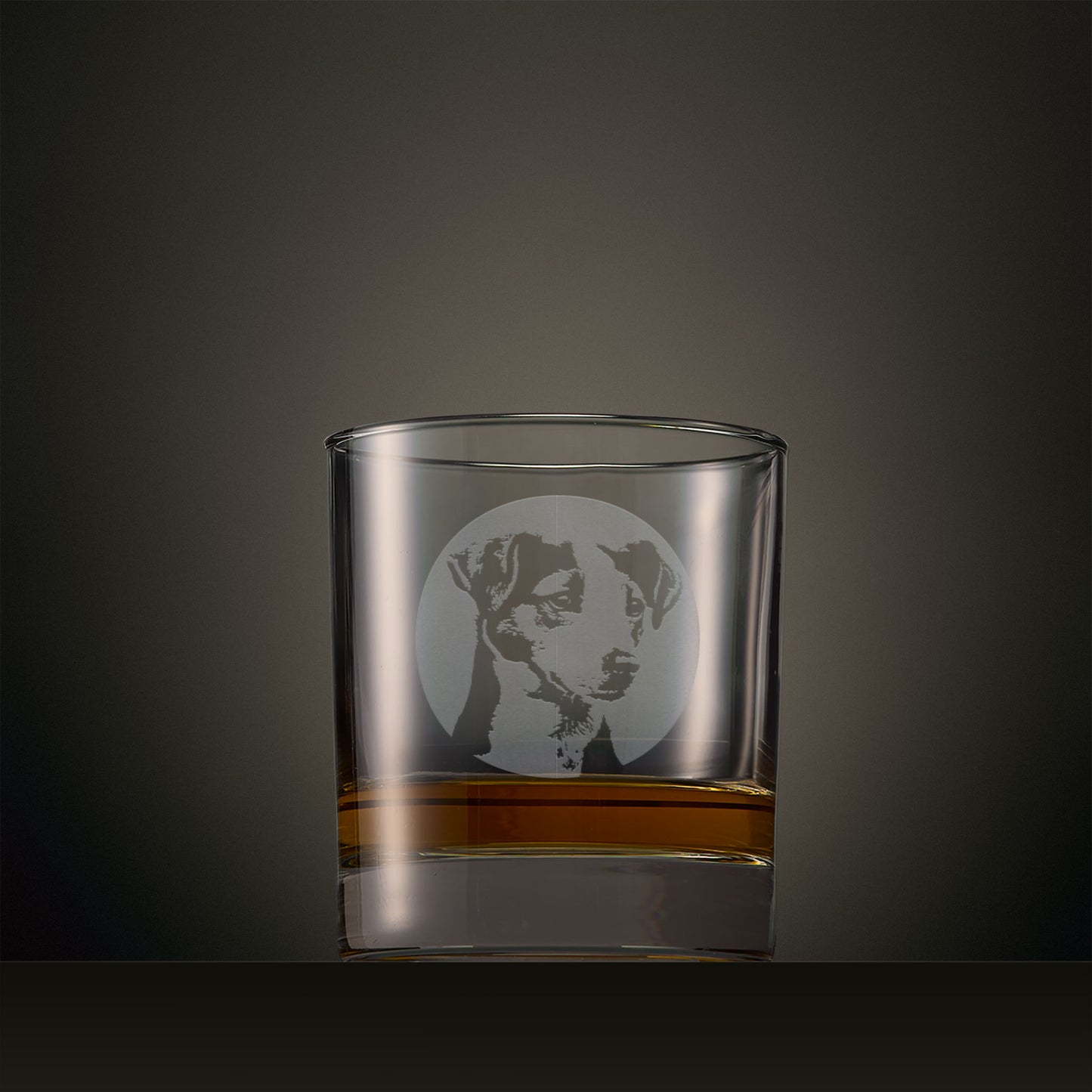 Engraved whisky glass featuring a Jack Russell Terrier portrait set within a circular design, photographed on a studio background
