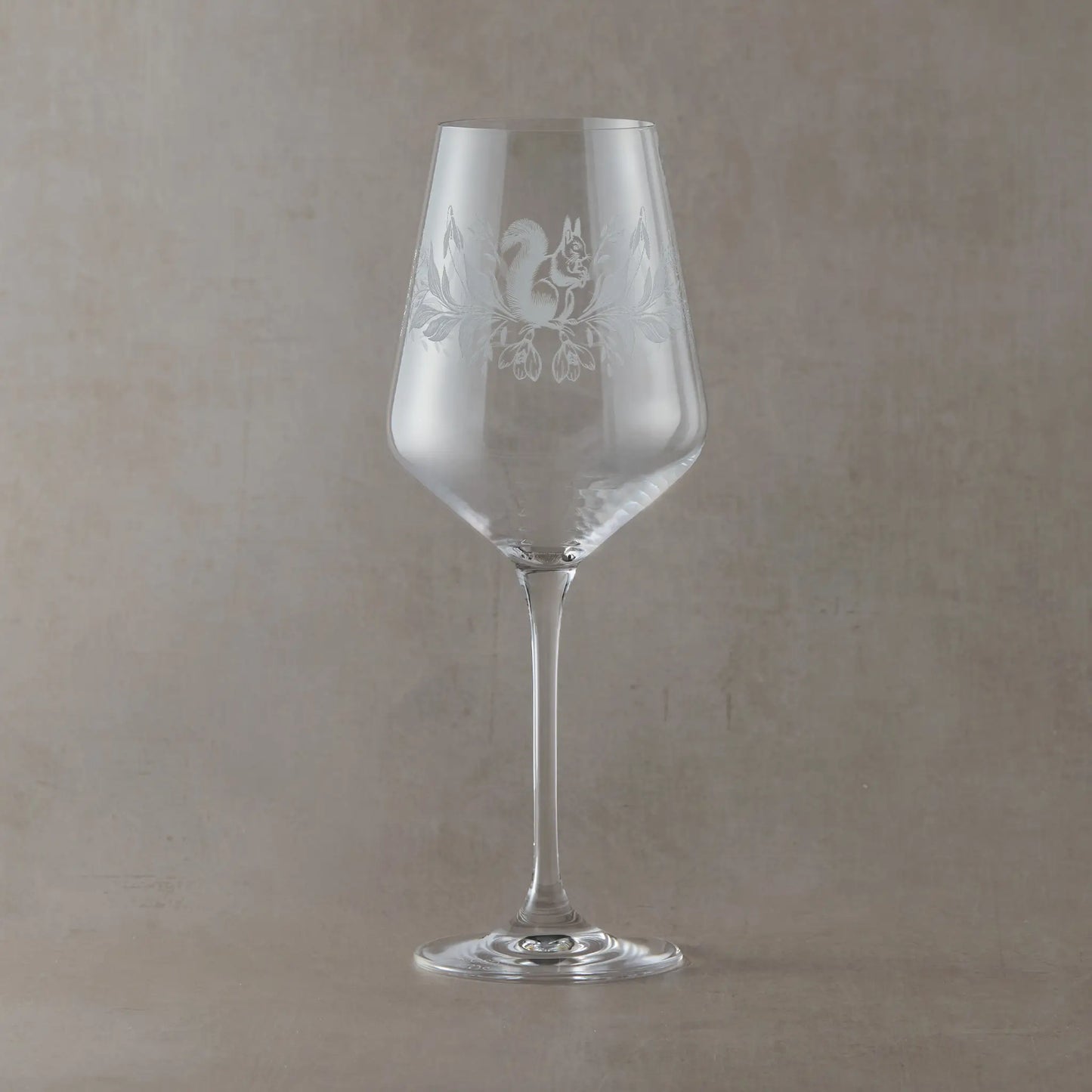 Engraved wine glass with January birth flowers, snowdrops and squirrel in a wraparound design