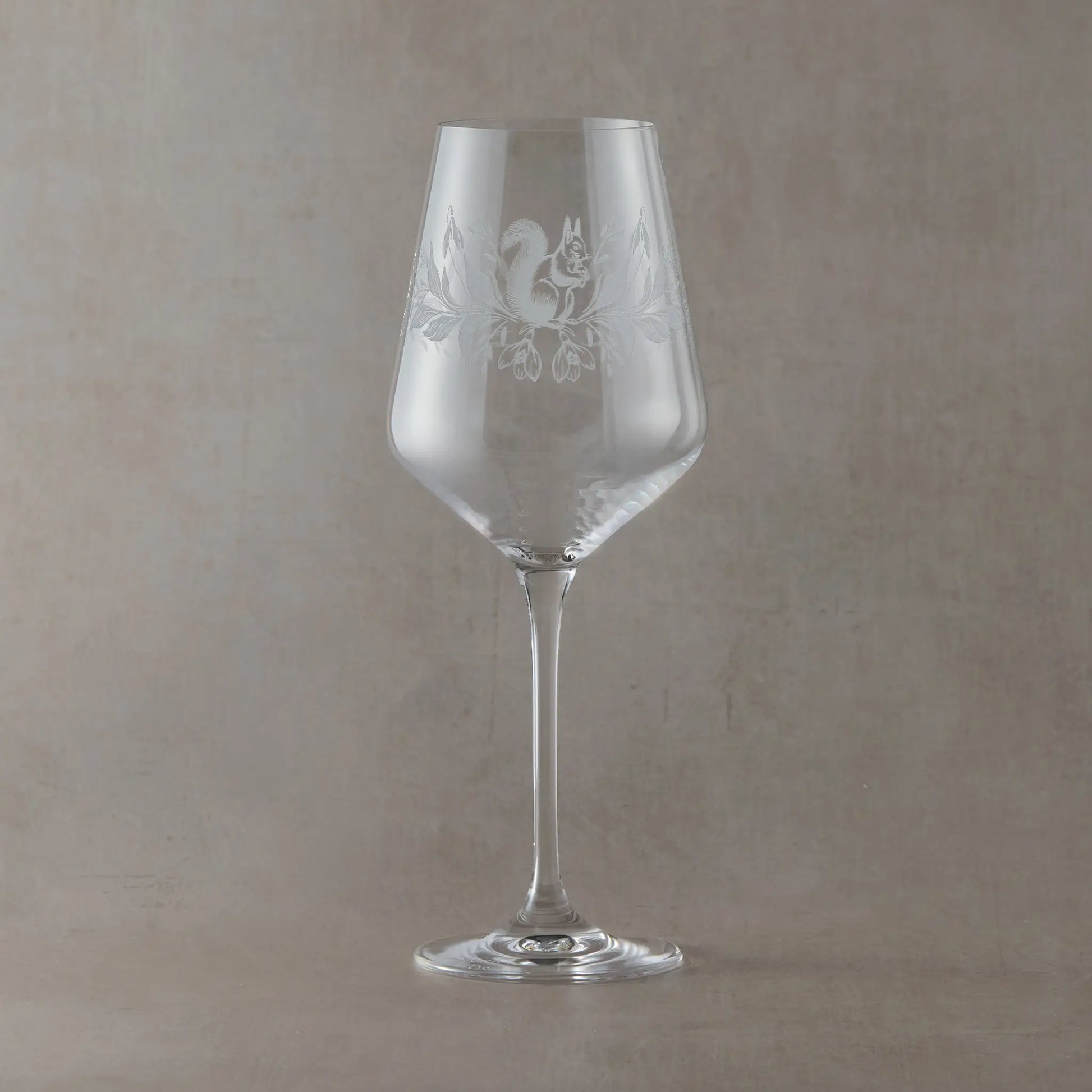 Engraved wine glass with January birth flowers, snowdrops and squirrel in a wraparound design