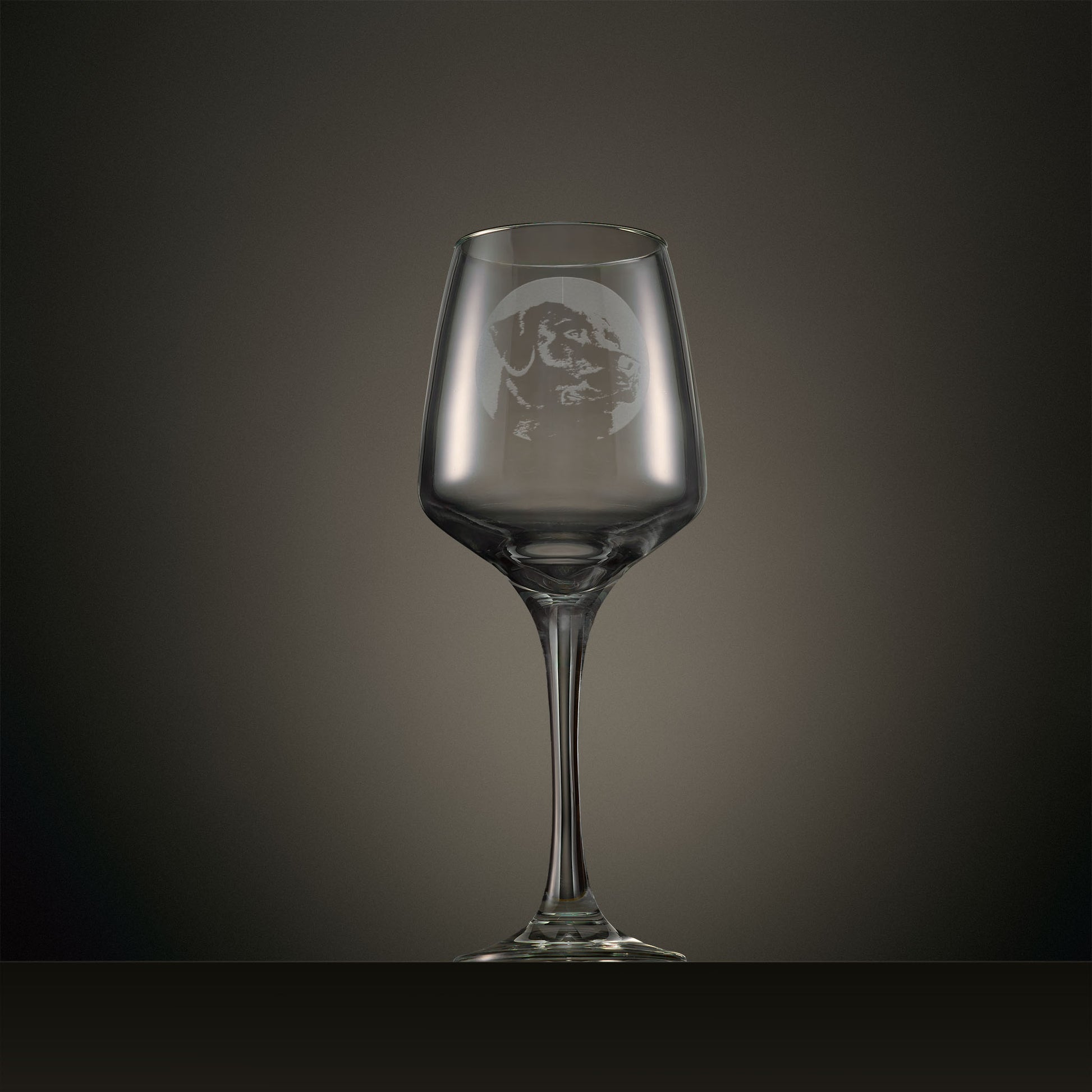 Engraved wine glass featuring a portrait Labrador design, shown on a dark studio background