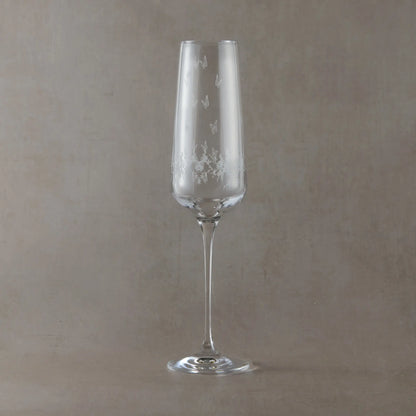 Engraved  champagne flute featuring a wraparound floral garland, butterflies and garden birds.