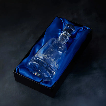 Engraved Le Jardin spirit decanter presented in a satin-lined gift box, photographed on deep blue background
