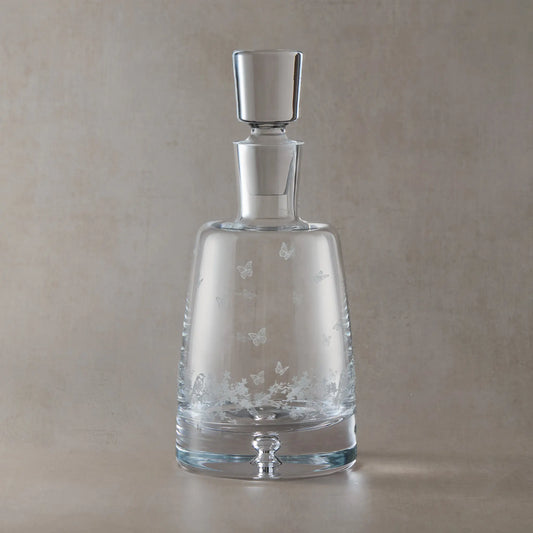 Engraved Le Jardin spirit decanter with wraparound floral garland, garden birds and butterflies on a beige background