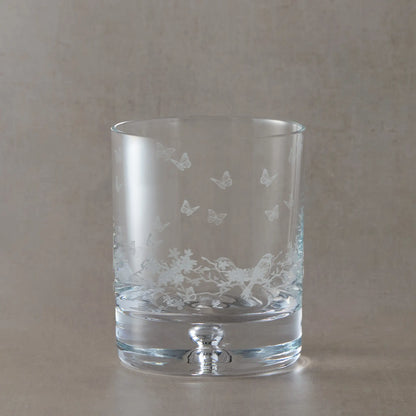Engraved whisky glass featuring a wraparound floral garland, garden birds and butterflies