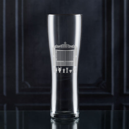 Pint glass with engraved LFC shankly gates and championship trophies design on a dark background