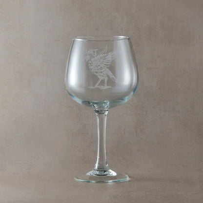 Gin glass engraved with a Liverbird facing left, photographed on a light background