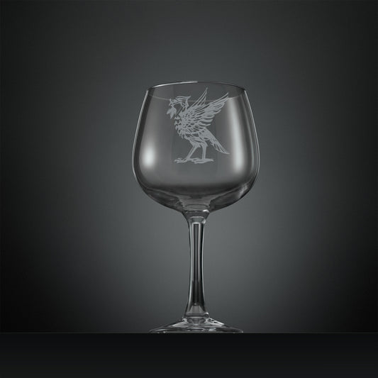 Balloon gin glass with engraved Liverbird facing left design on a dark gray background