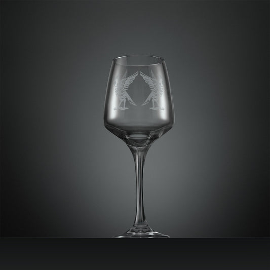 Clear wine glass with two engraved Liverbirds design on a dark gray background