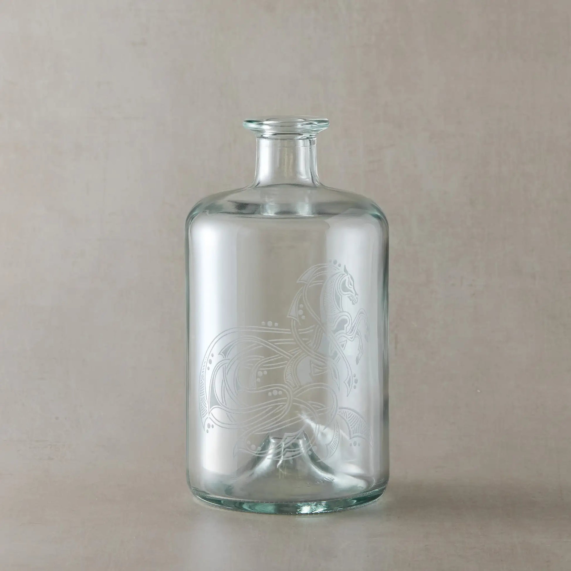Celtic decanter bottle engraved with a knotwork horse, circles and flowing anamorphic ribbon design