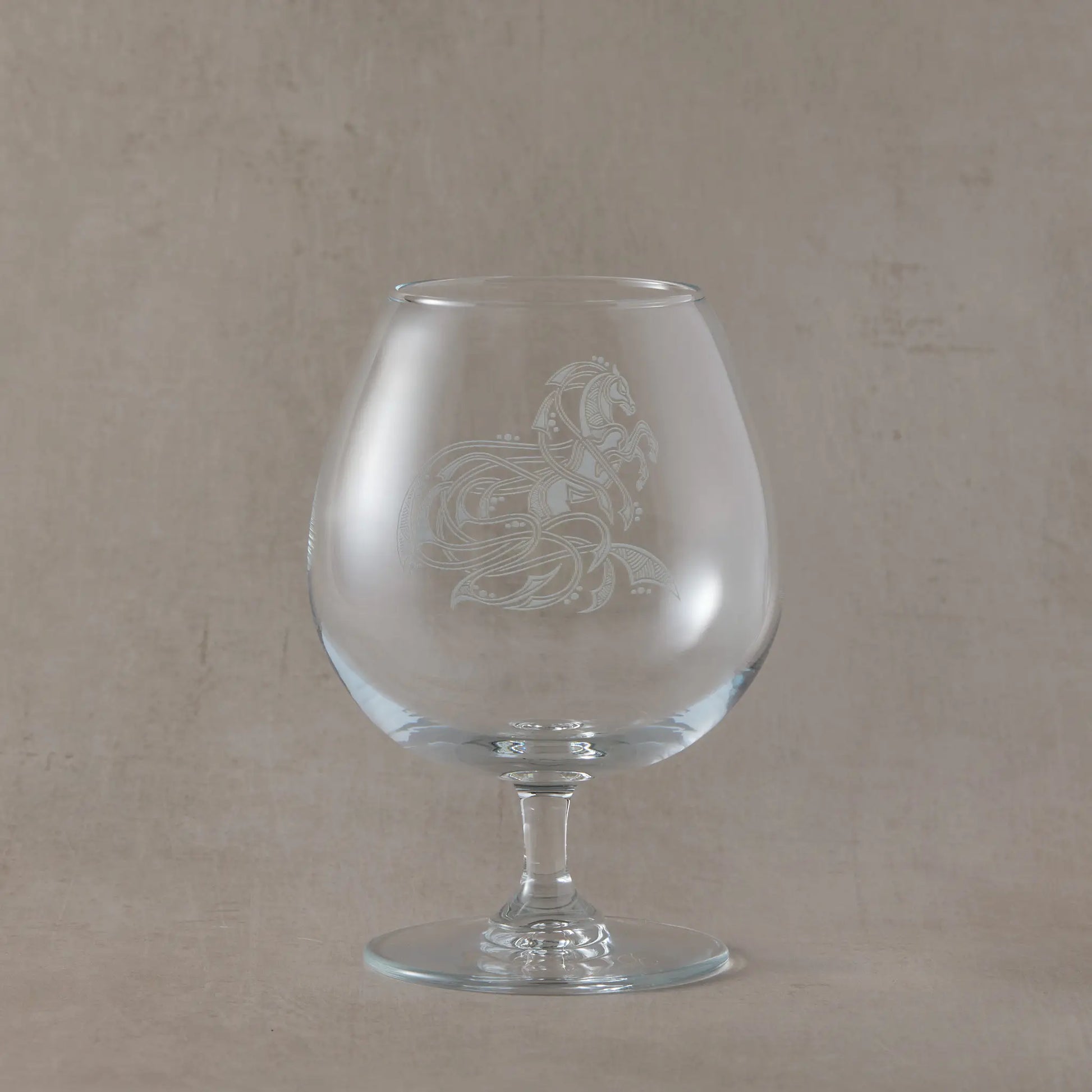 Engraved brandy glass with an  illustration of a celtic knotwork horse