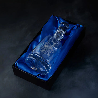 Engraved stag spirit decanter presented in a satin-lined gift box, photographed on deep blue background