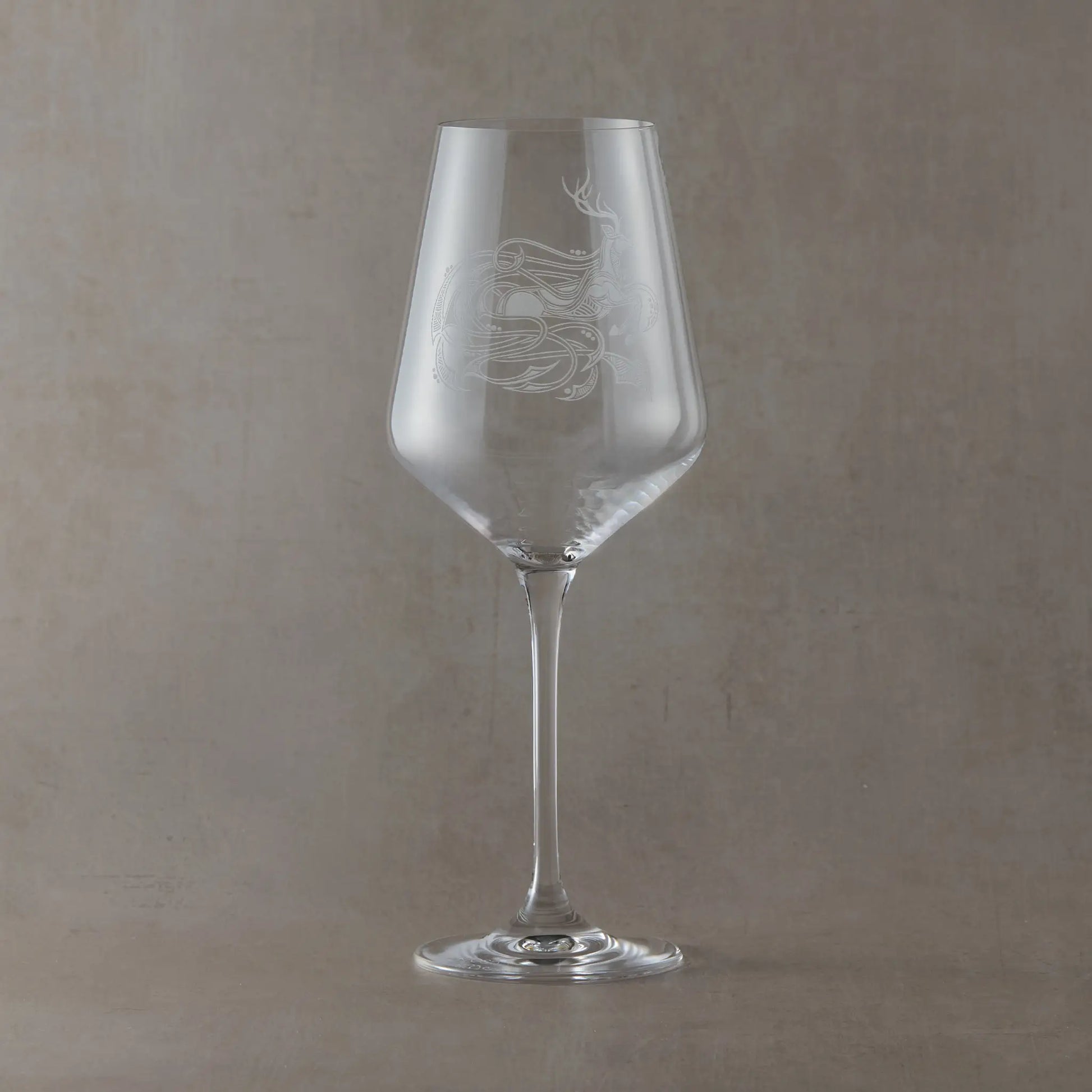Wine glass engraved with a Celtic stag with entwined anamorphic waves