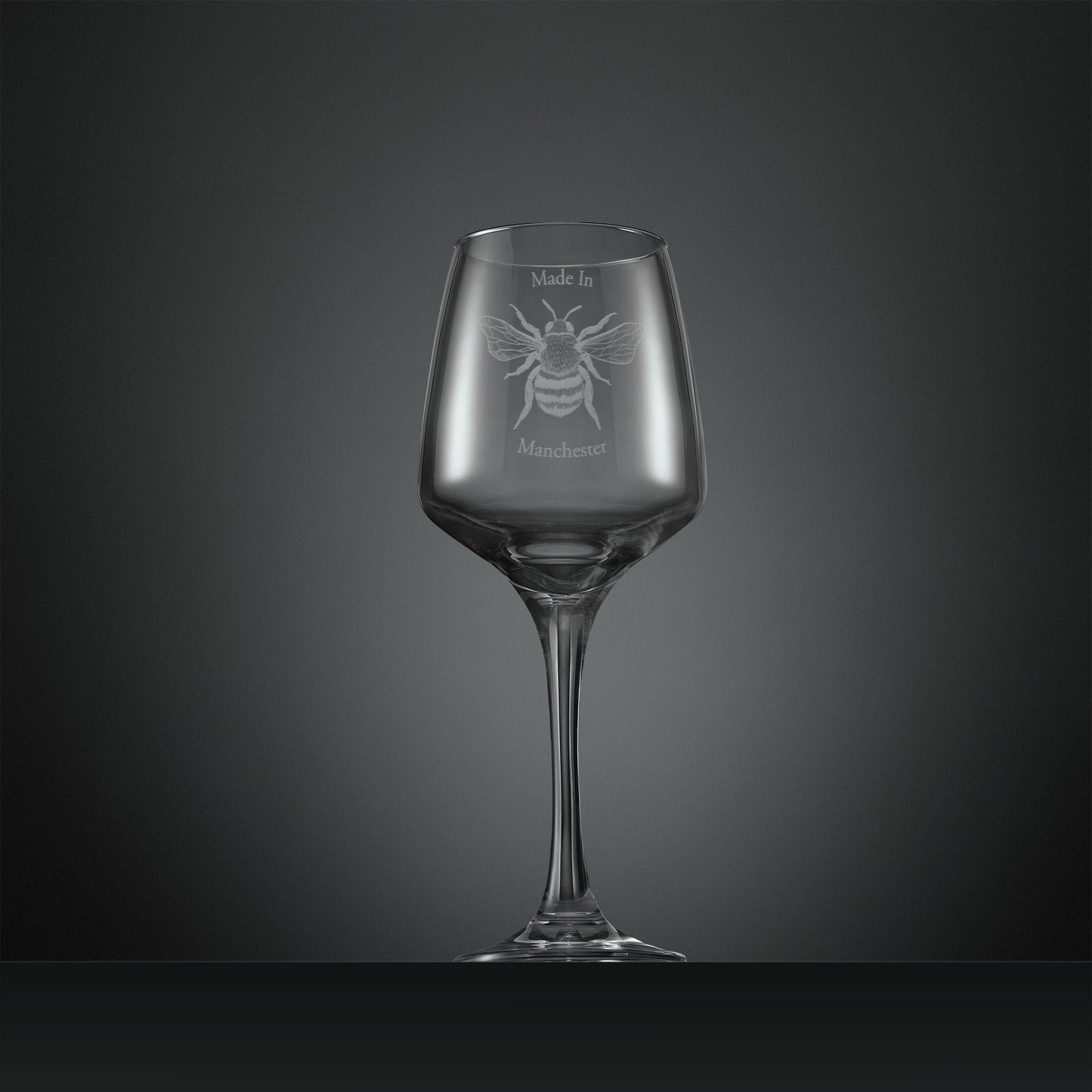 Engraved wine glass with Manchester Bee and text