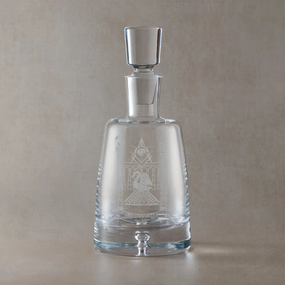 Handmade engraved spirit decanter featuring a Masonic lodge crest, sandblasted onto clear glass against a neutral beige studio background