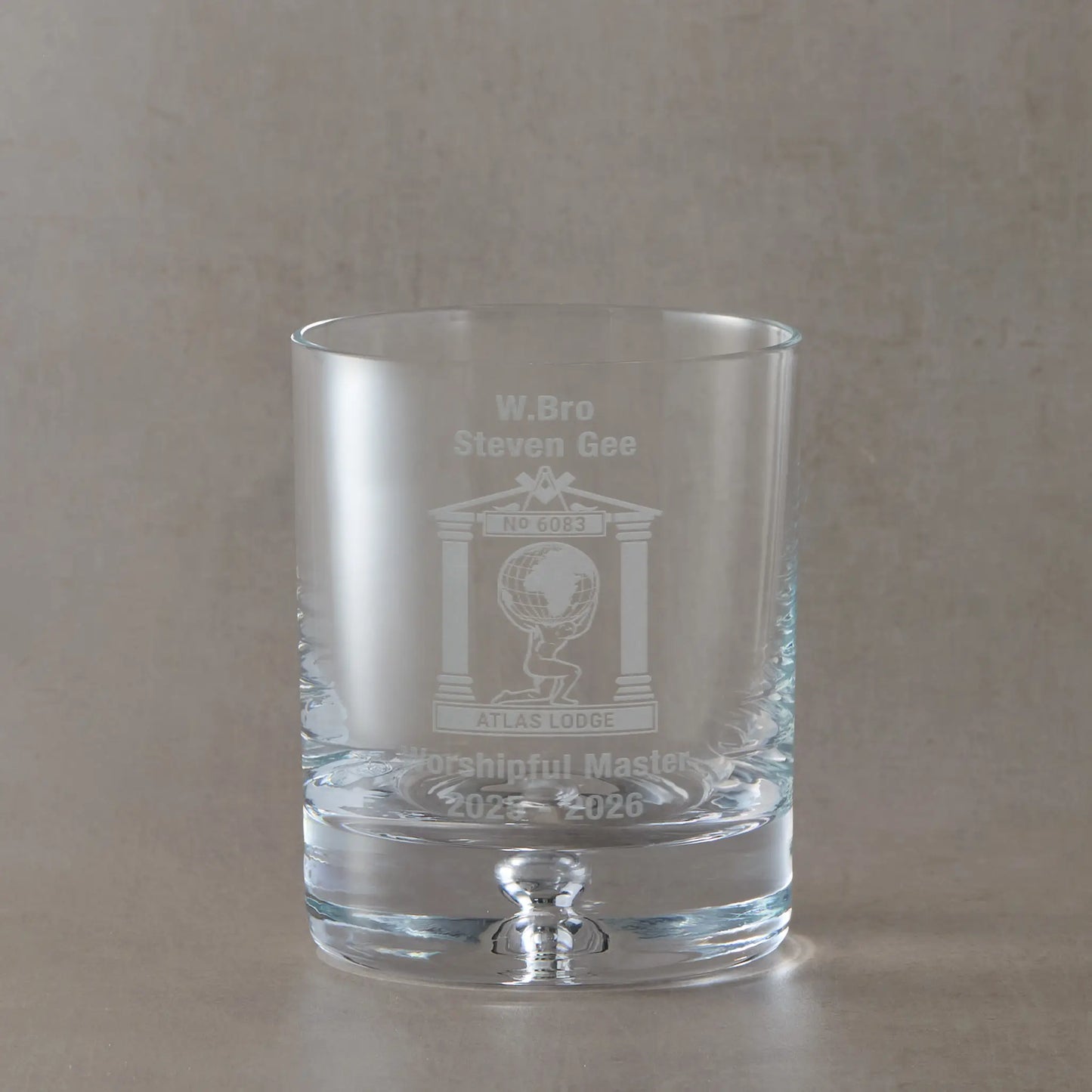Engraved bubble-based whisky glass featuring a personalised Masonic lodge crest, with Worshipful Master name and dates, photographed on a soft neutral studio background